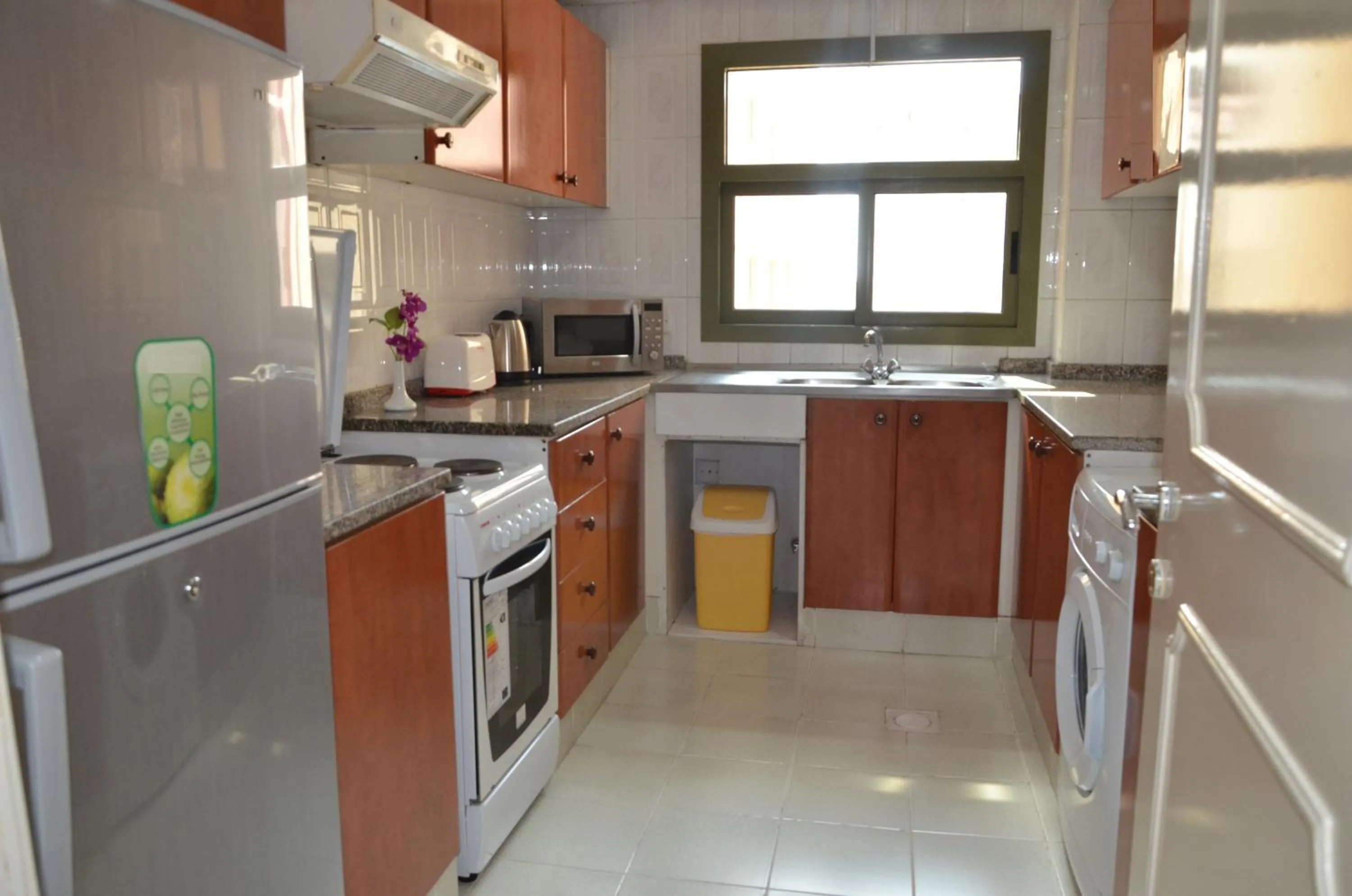Kitchen or kitchenette in Al Jazeera Hotel Apartments LLC