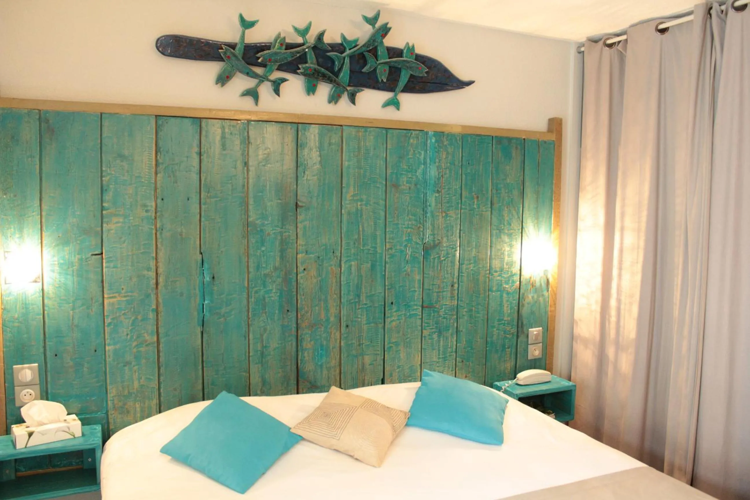 Bed in Logis Hôtel Les Grenadines