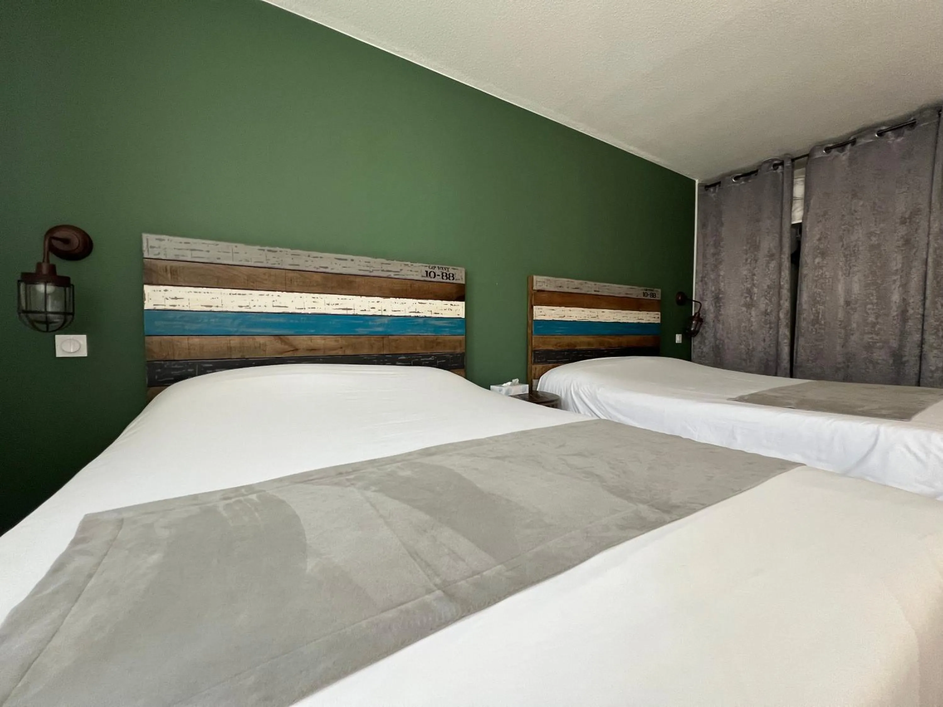 Bed in Logis Hôtel Les Grenadines