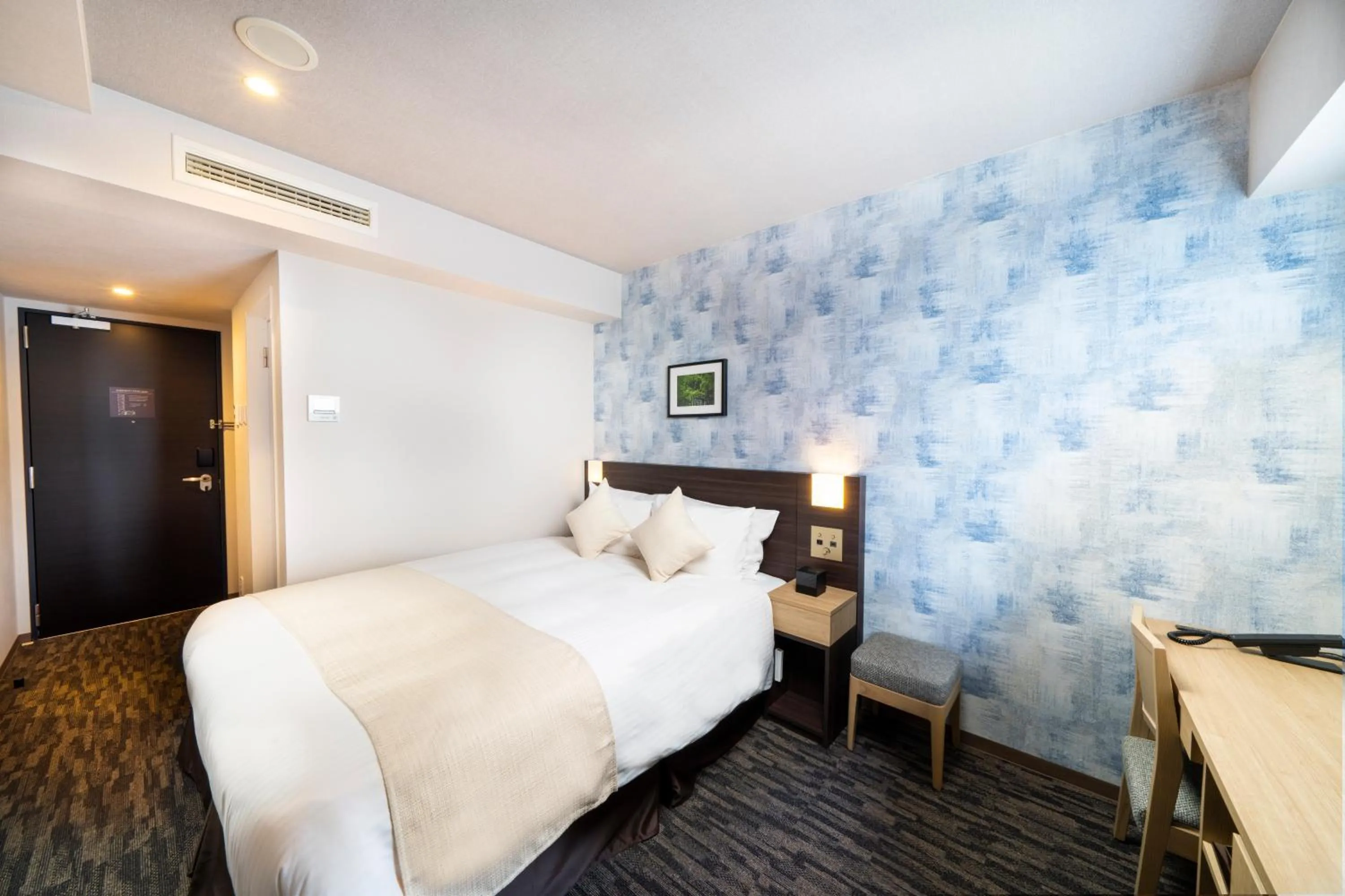 Bed in KOKO HOTEL Sapporo Odori