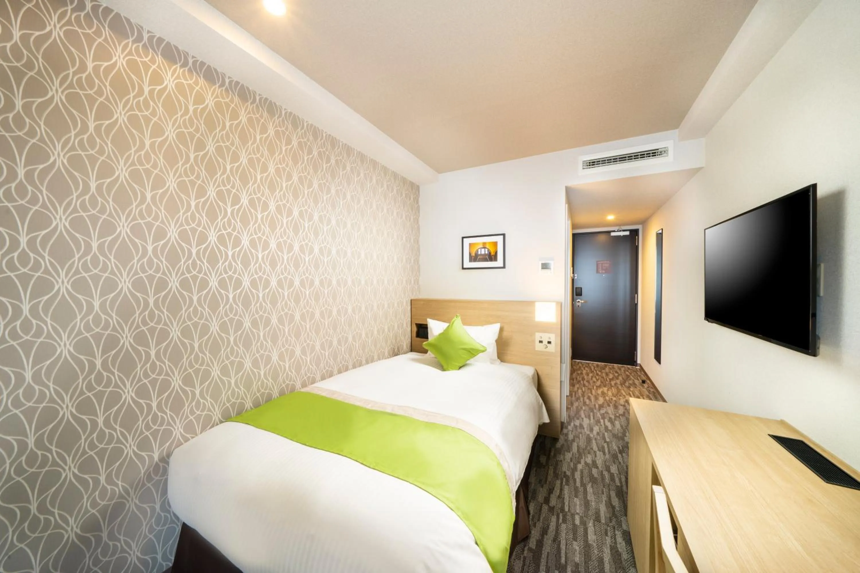 Bed in KOKO HOTEL Sapporo Odori