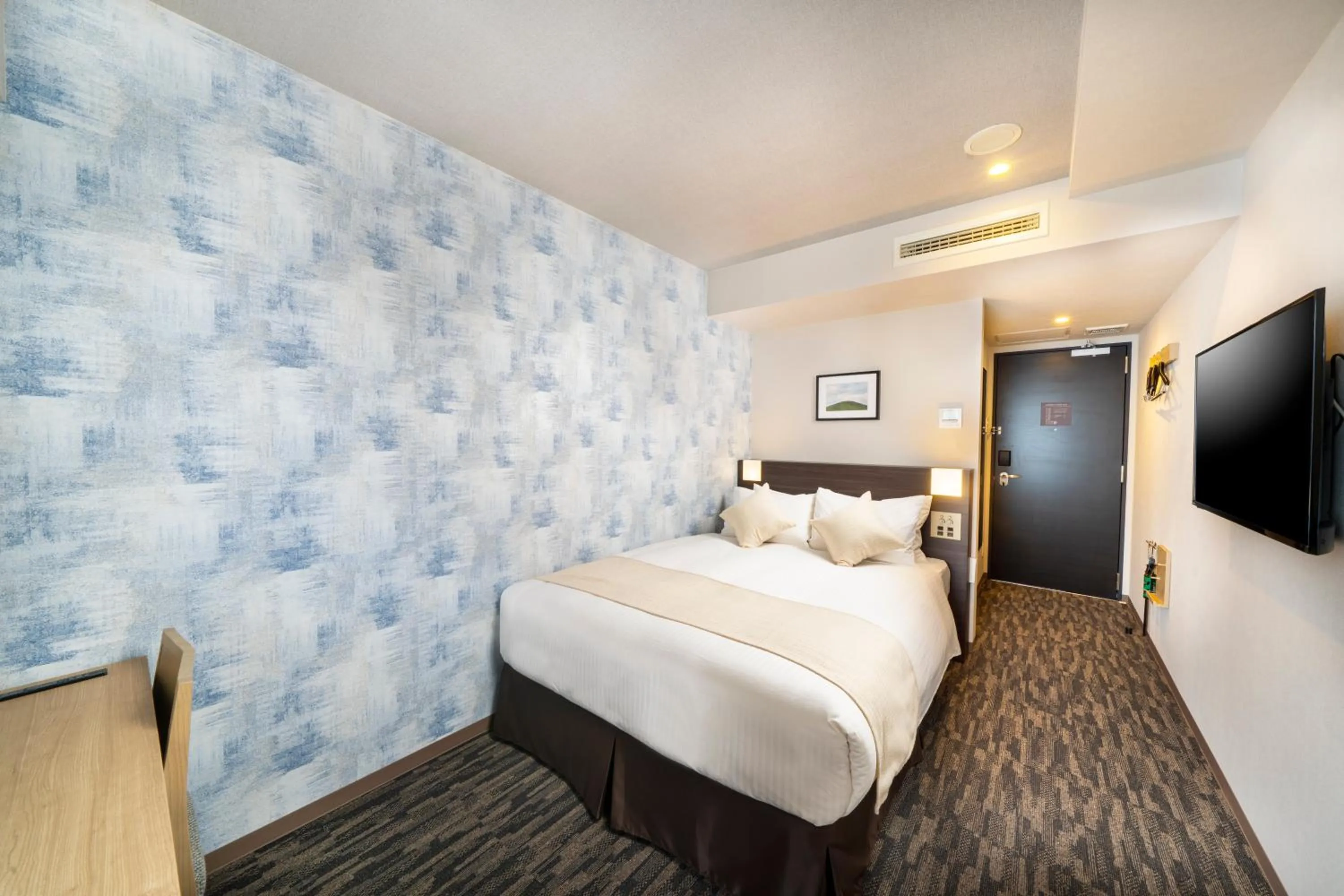 Bed in KOKO HOTEL Sapporo Odori