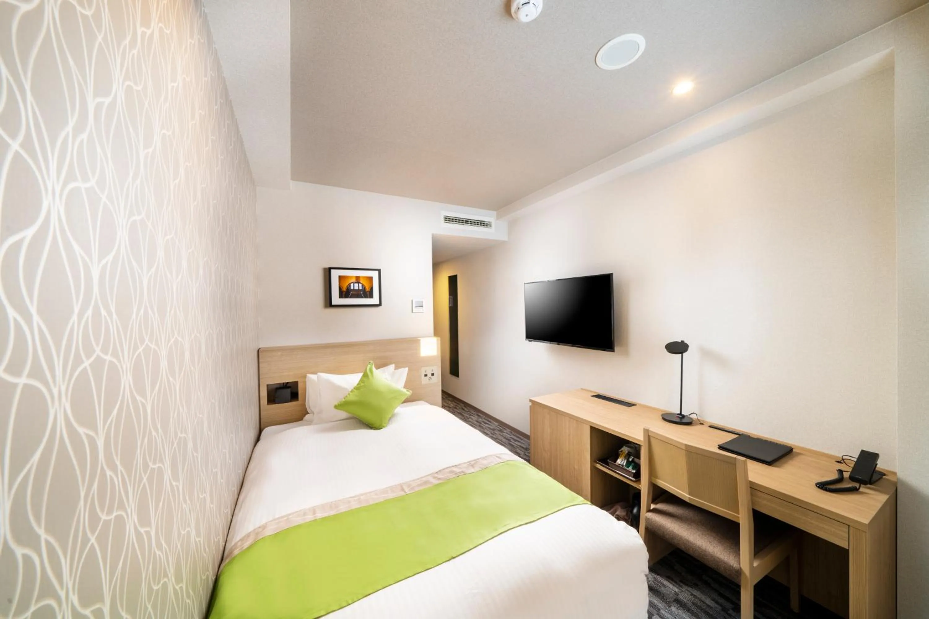 Bed in KOKO HOTEL Sapporo Odori