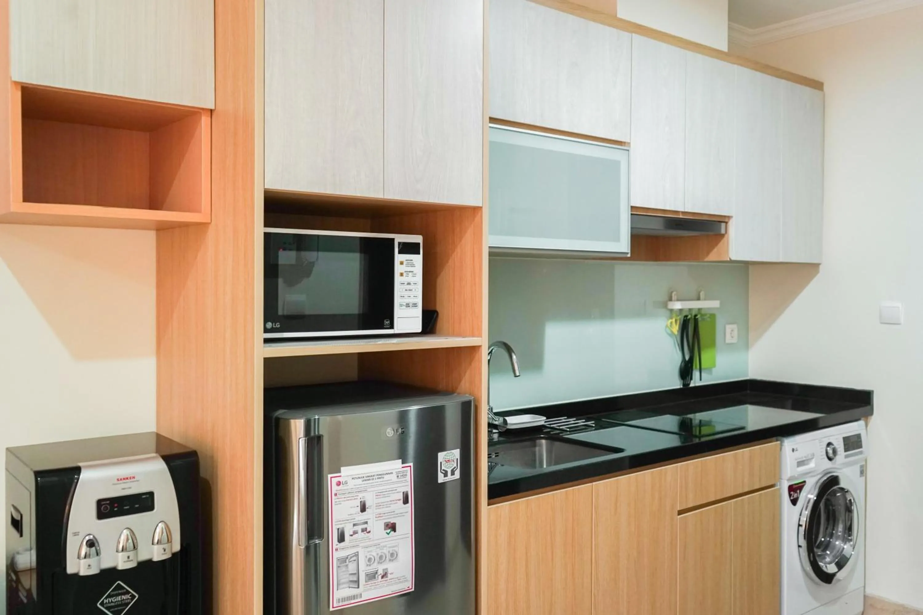 Kitchen or kitchenette in Stunning Studio Room at Menteng Park Apartment By Travelio