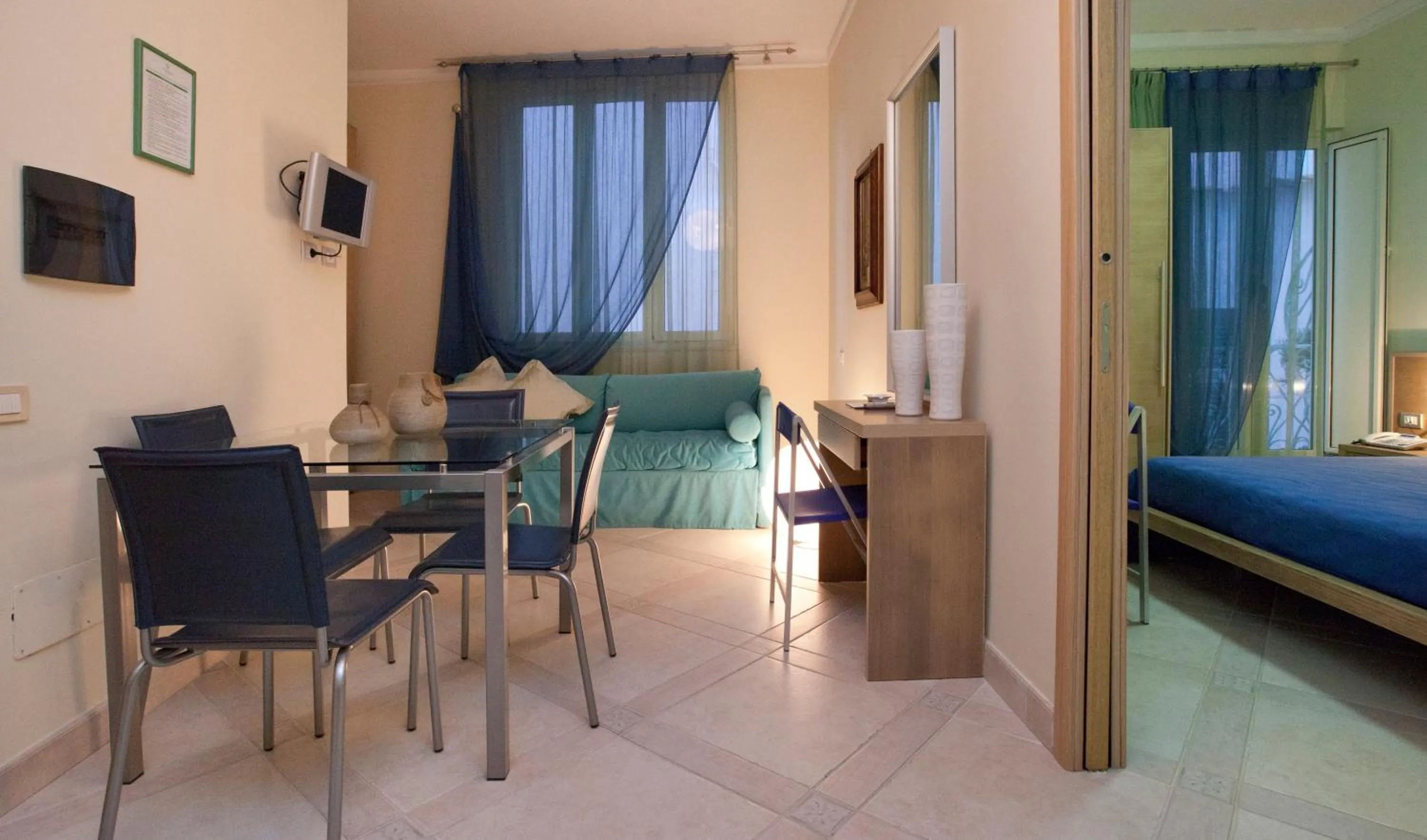 Dining area, Bed in Posidonia Residence