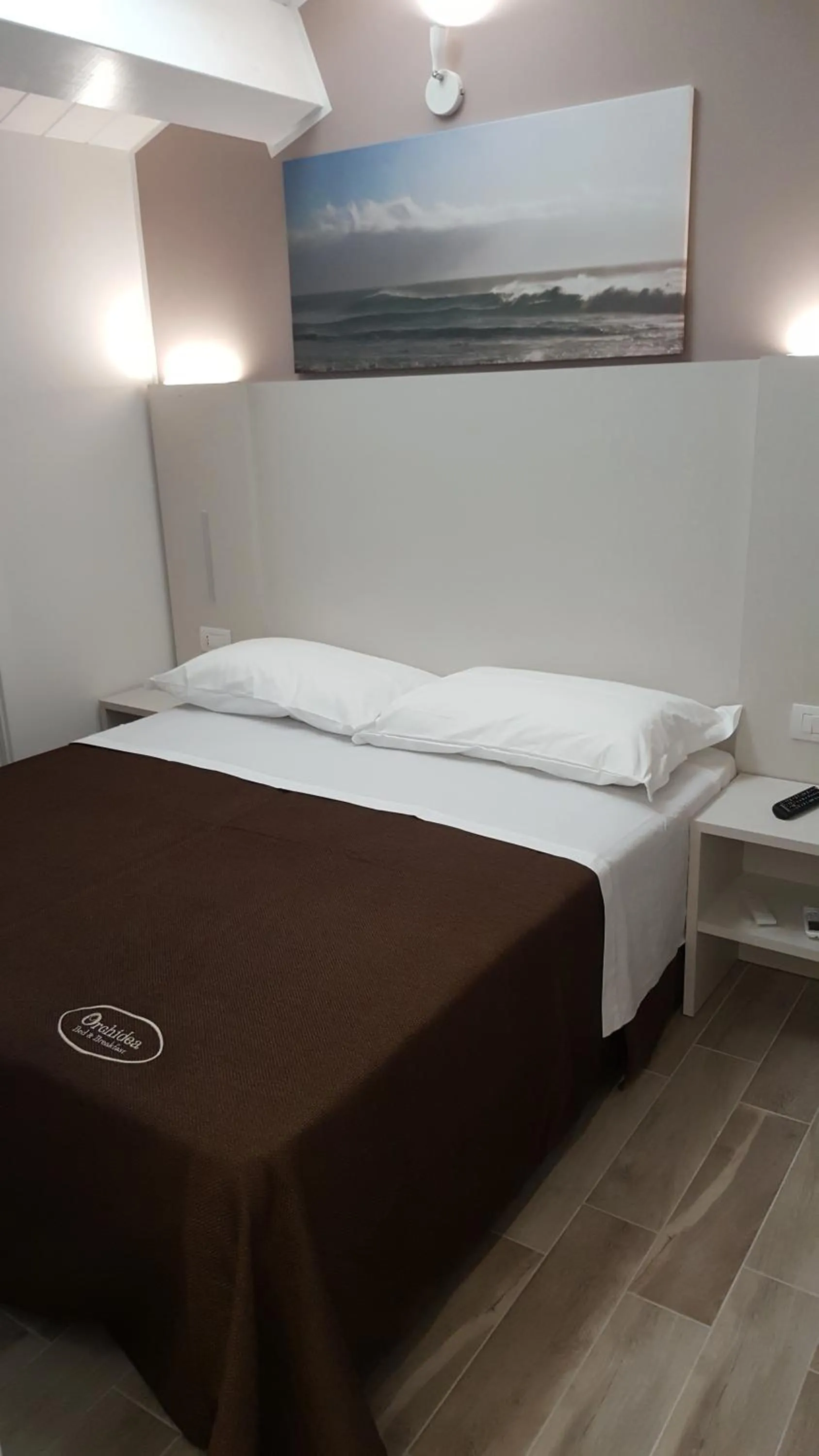 Bed in Orchidea Rooms & Suites