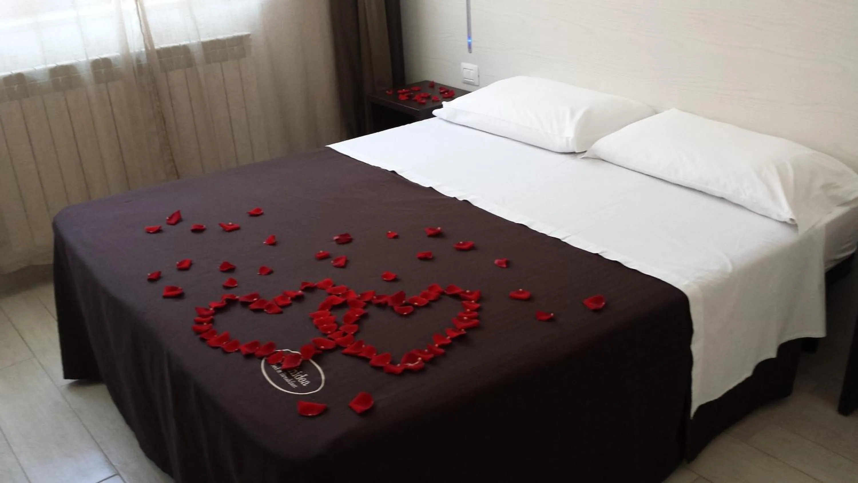 Bed in Orchidea Rooms & Suites