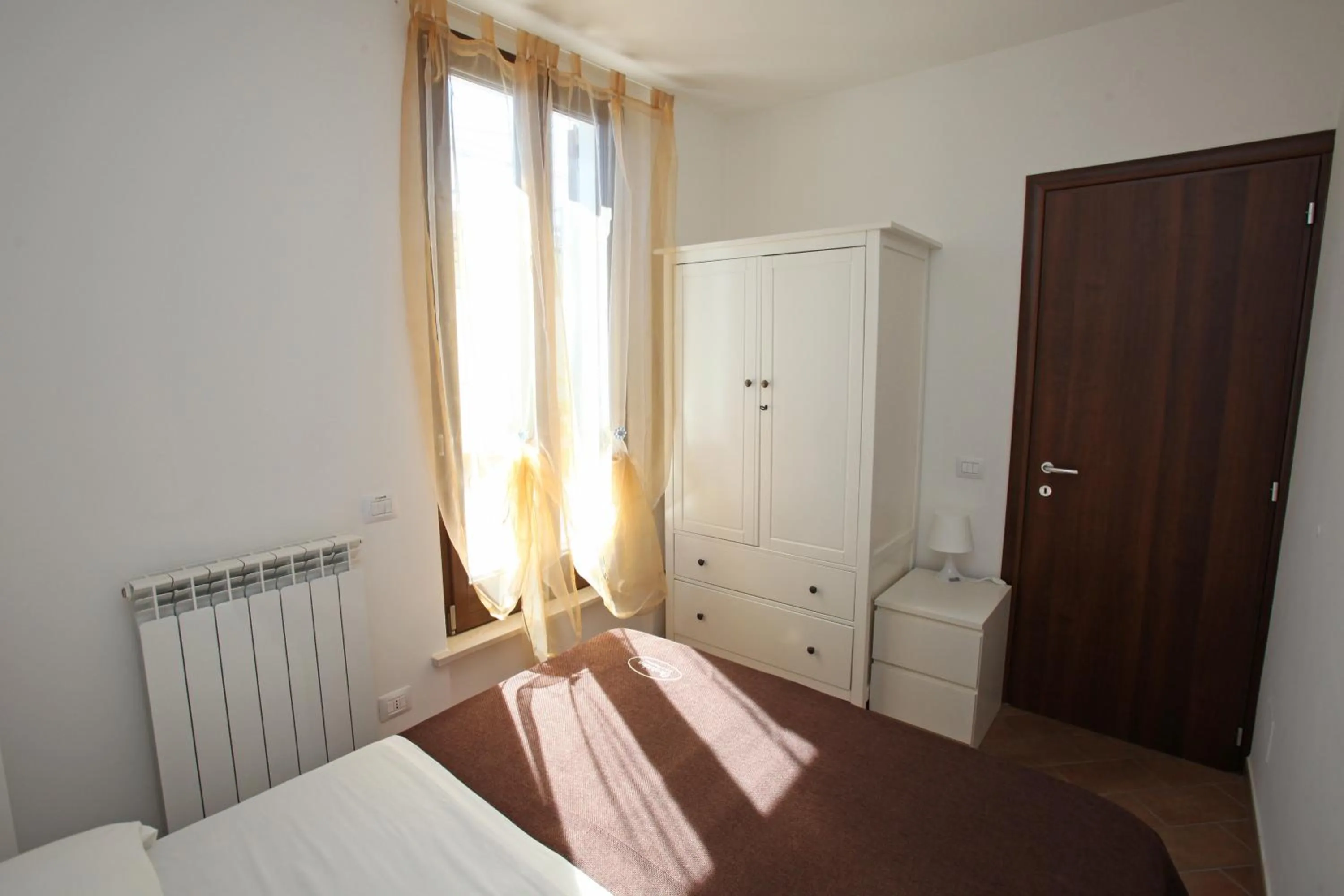 Bed in Orchidea Rooms & Suites