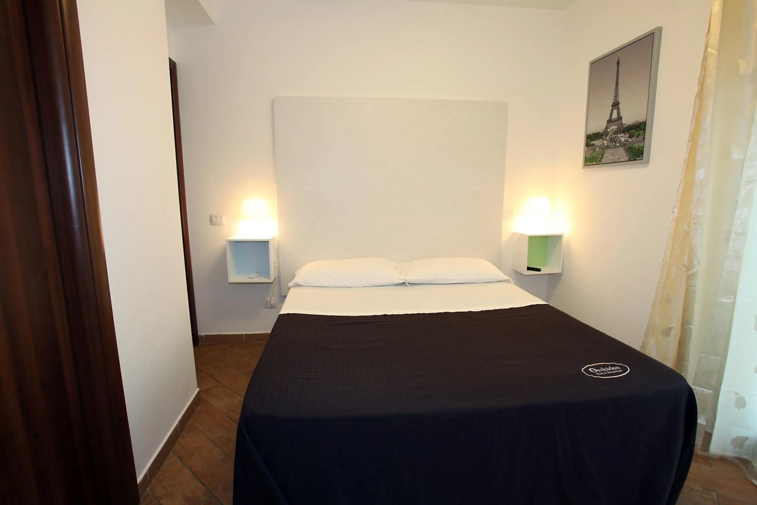 Bed in Orchidea Rooms & Suites