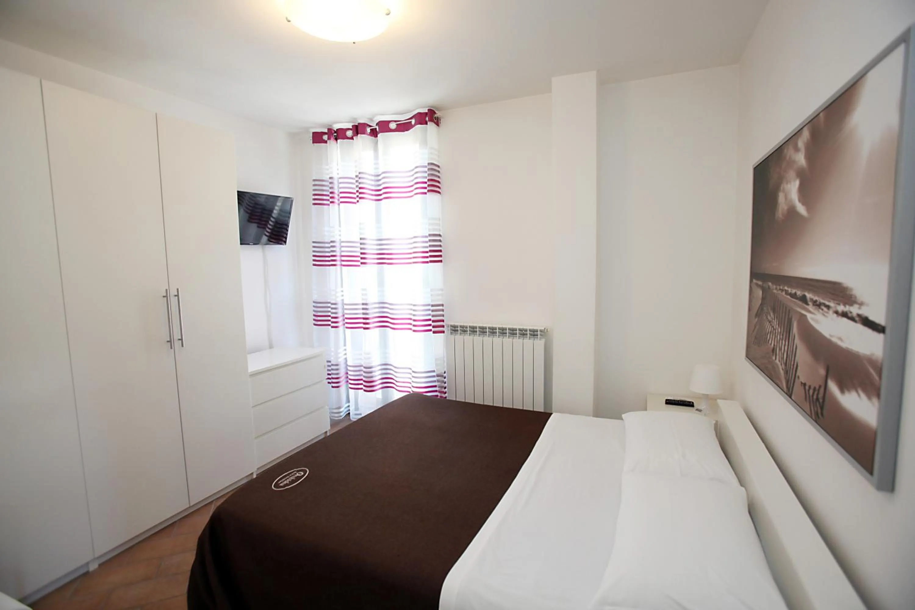Quiet street view, Bed in Orchidea Rooms & Suites
