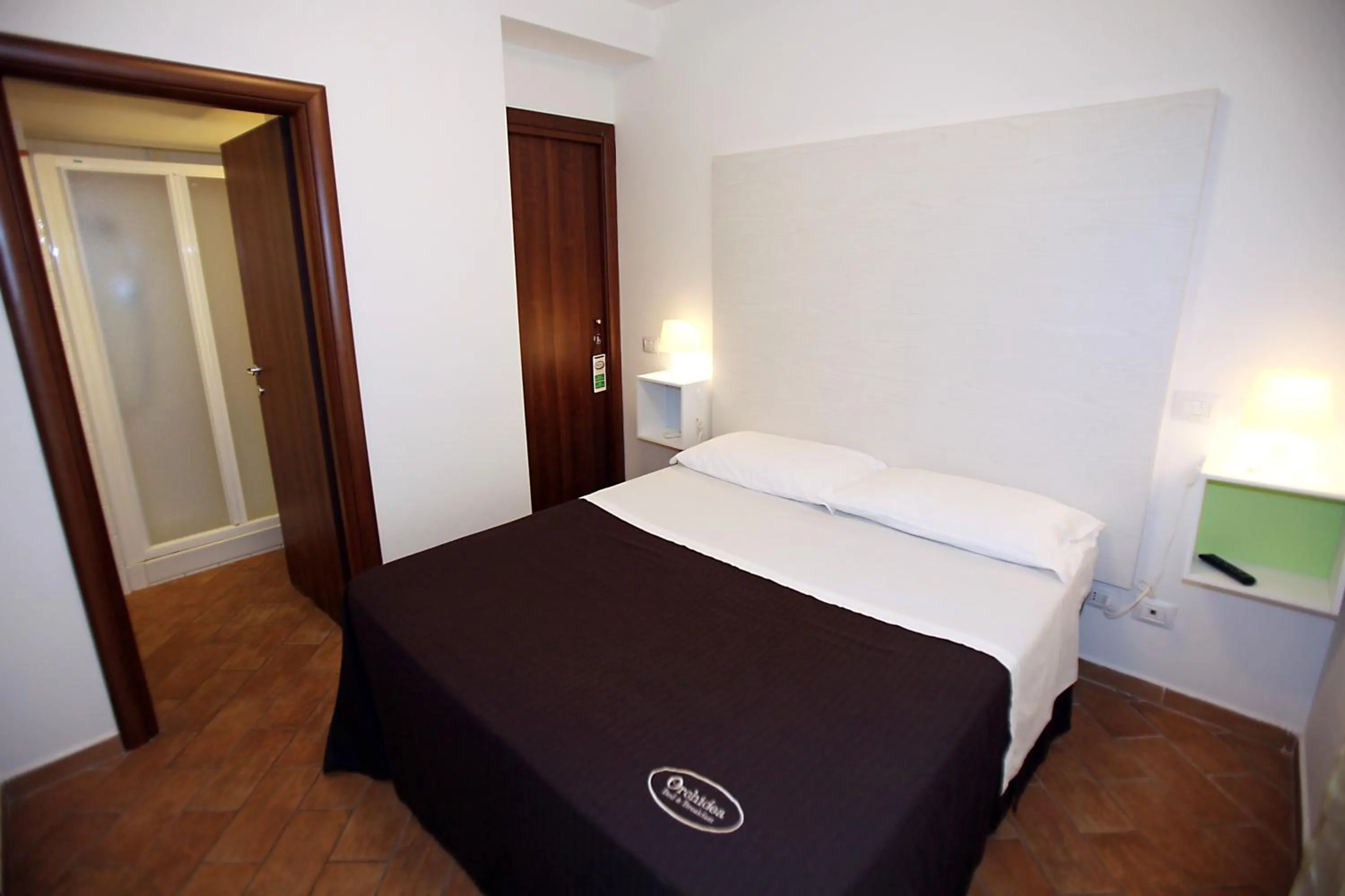 Bed in Orchidea Rooms & Suites