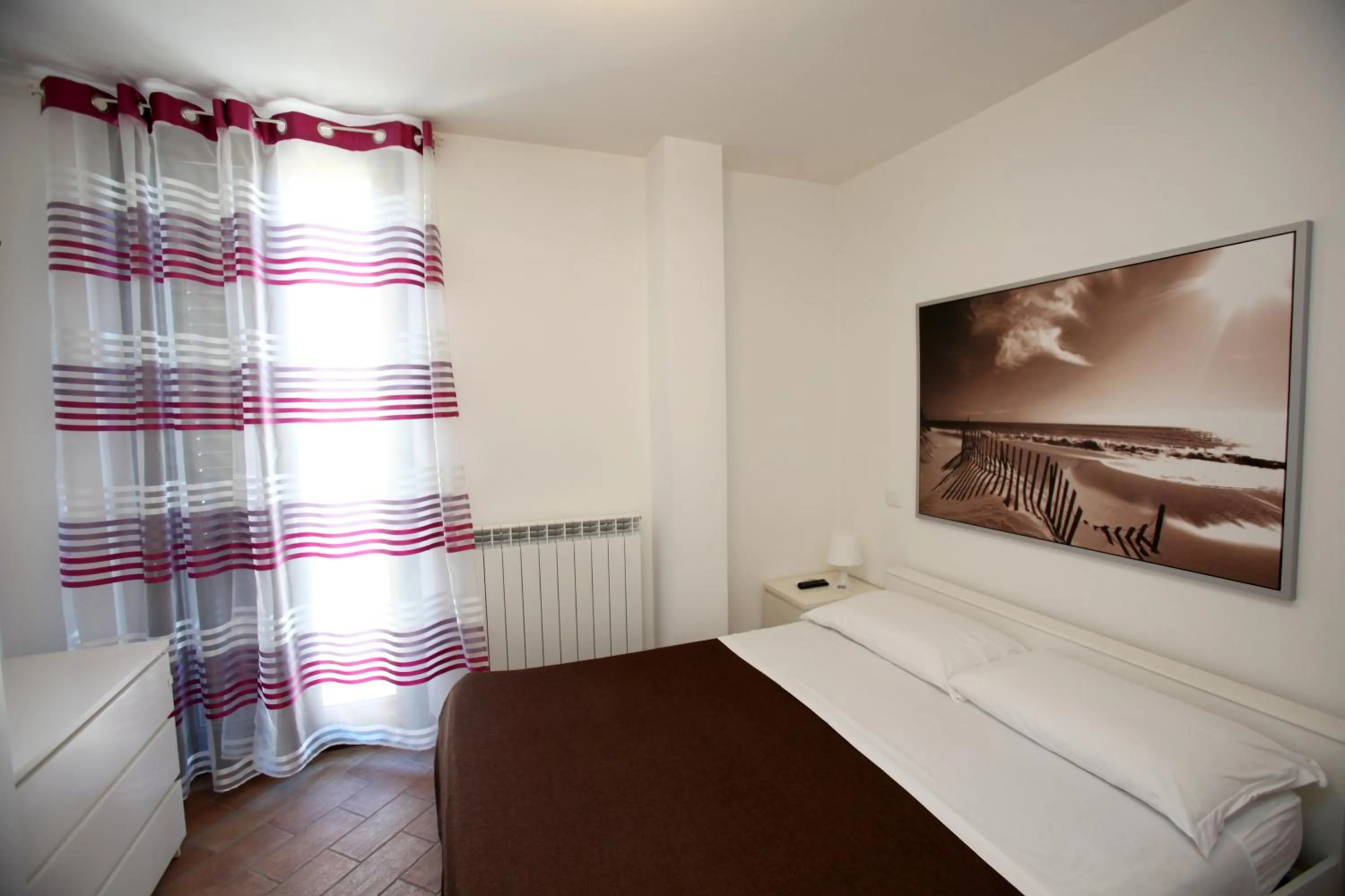 Bed in Orchidea Rooms & Suites