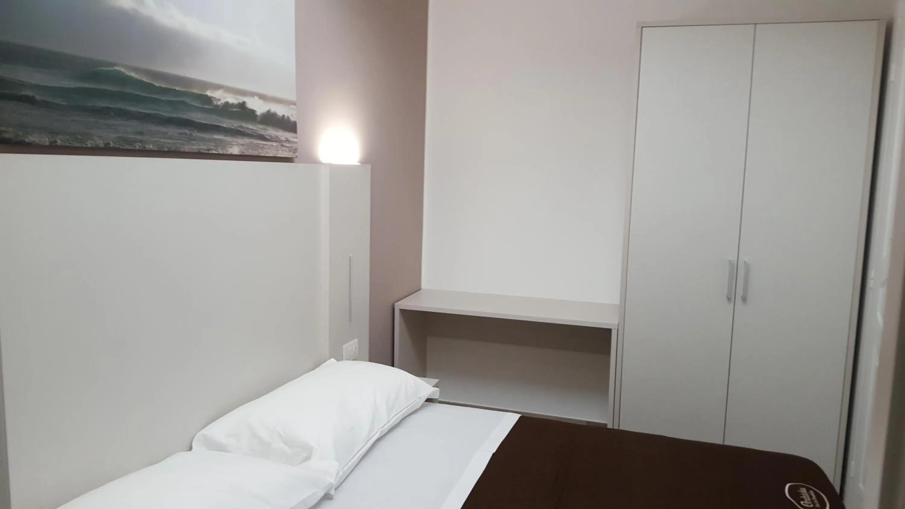 Bed in Orchidea Rooms & Suites