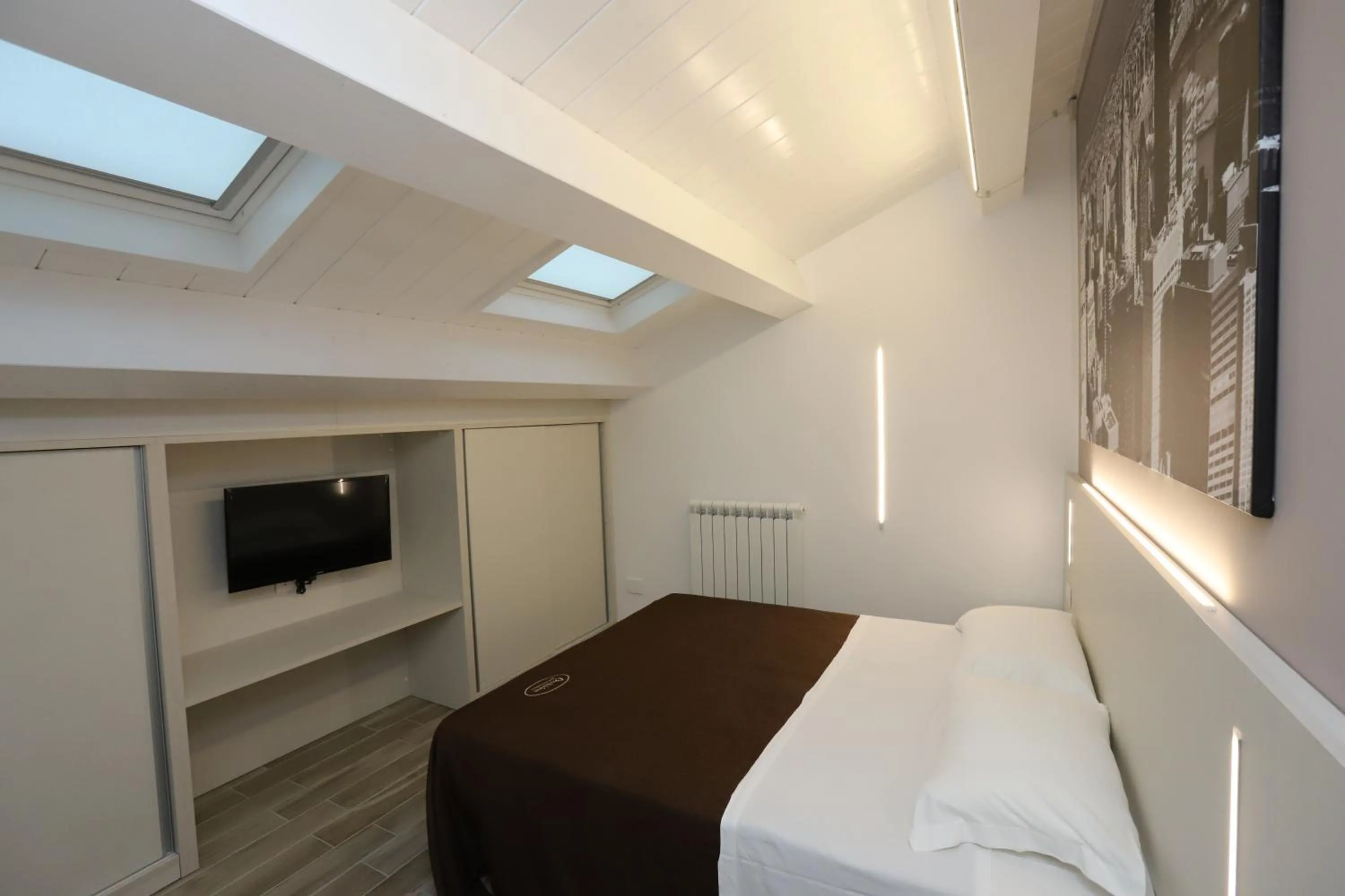Bed in Orchidea Rooms & Suites