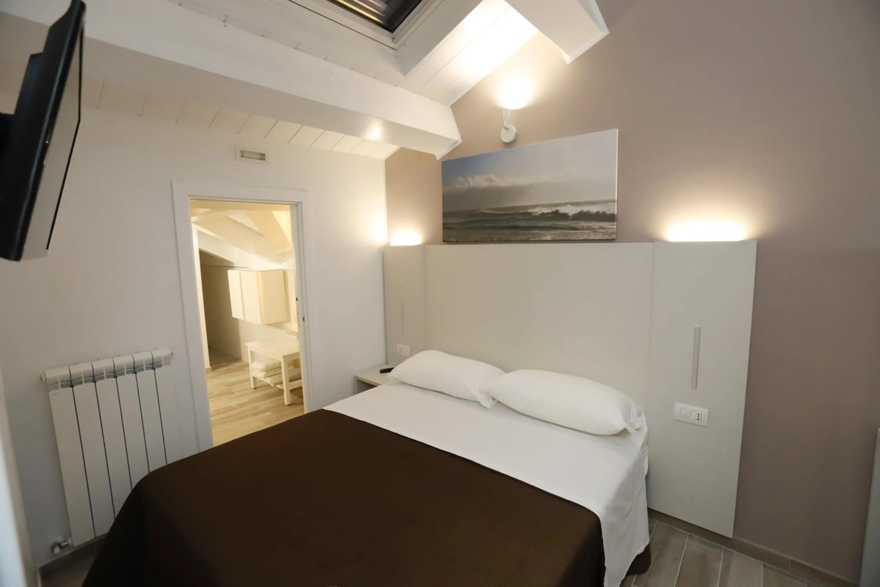 Bed in Orchidea Rooms & Suites