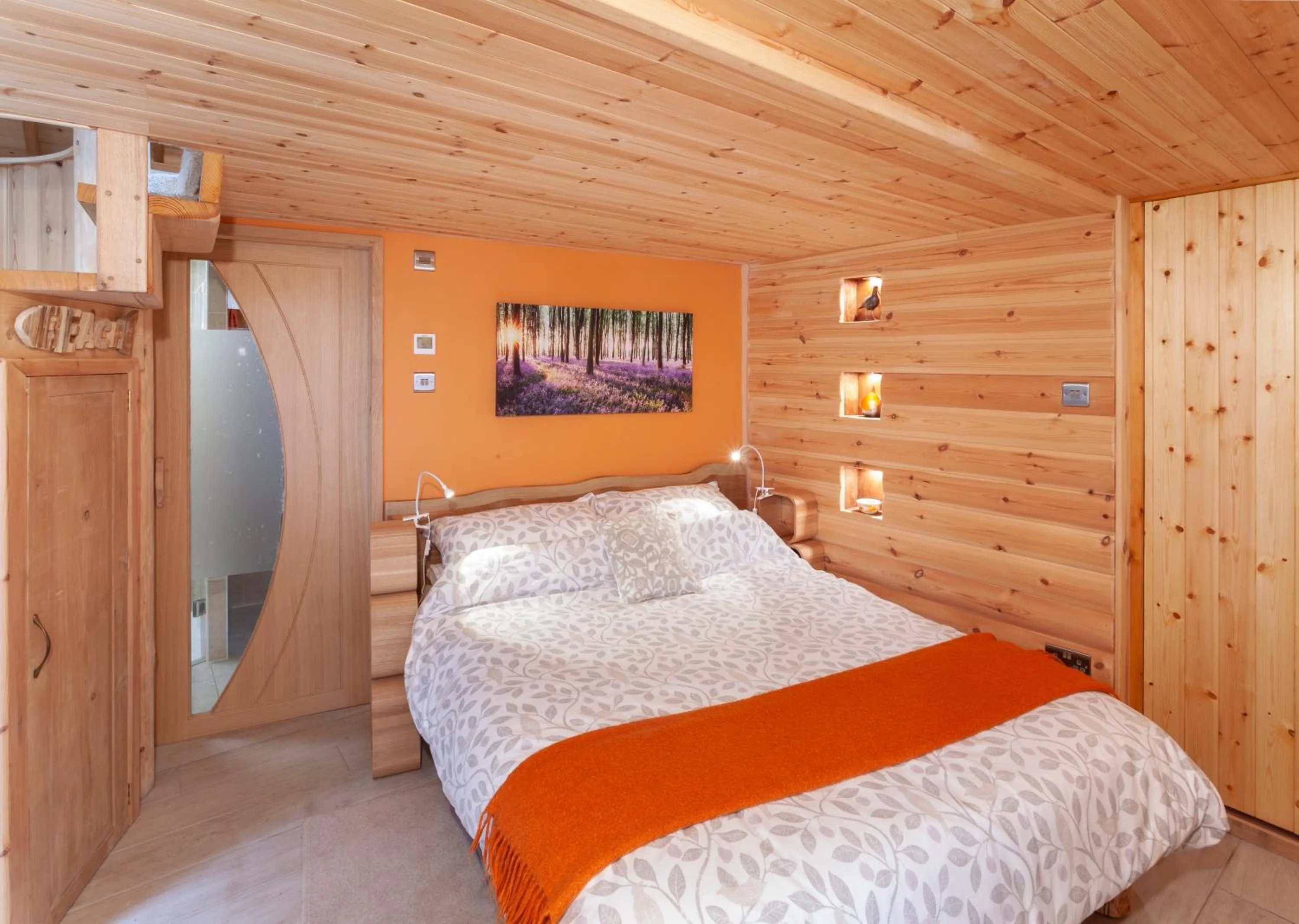 Bed in Porthole Log Cabin