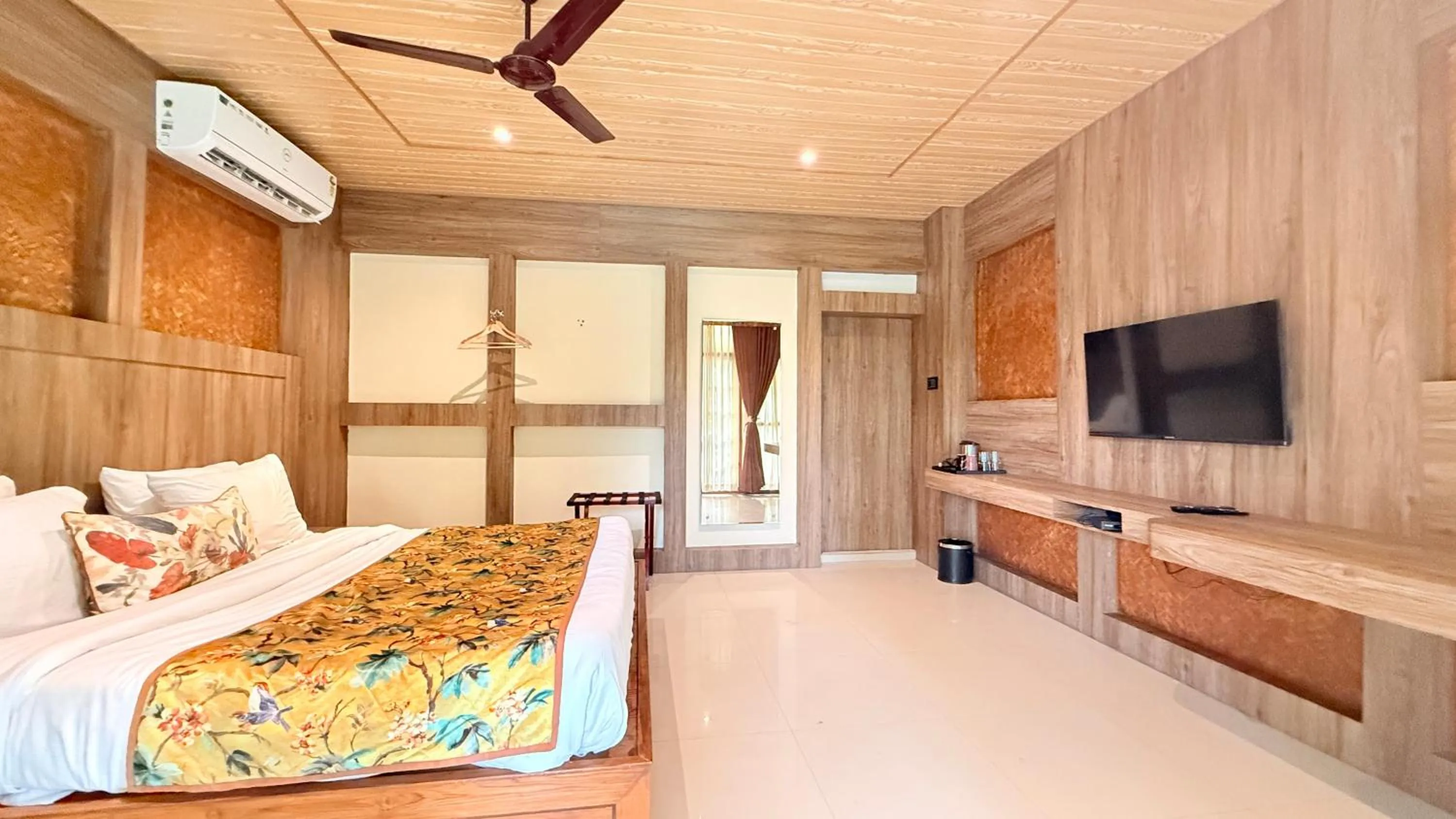 Communal lounge/ TV room, Bed in Kaziranga Eco Village Resort