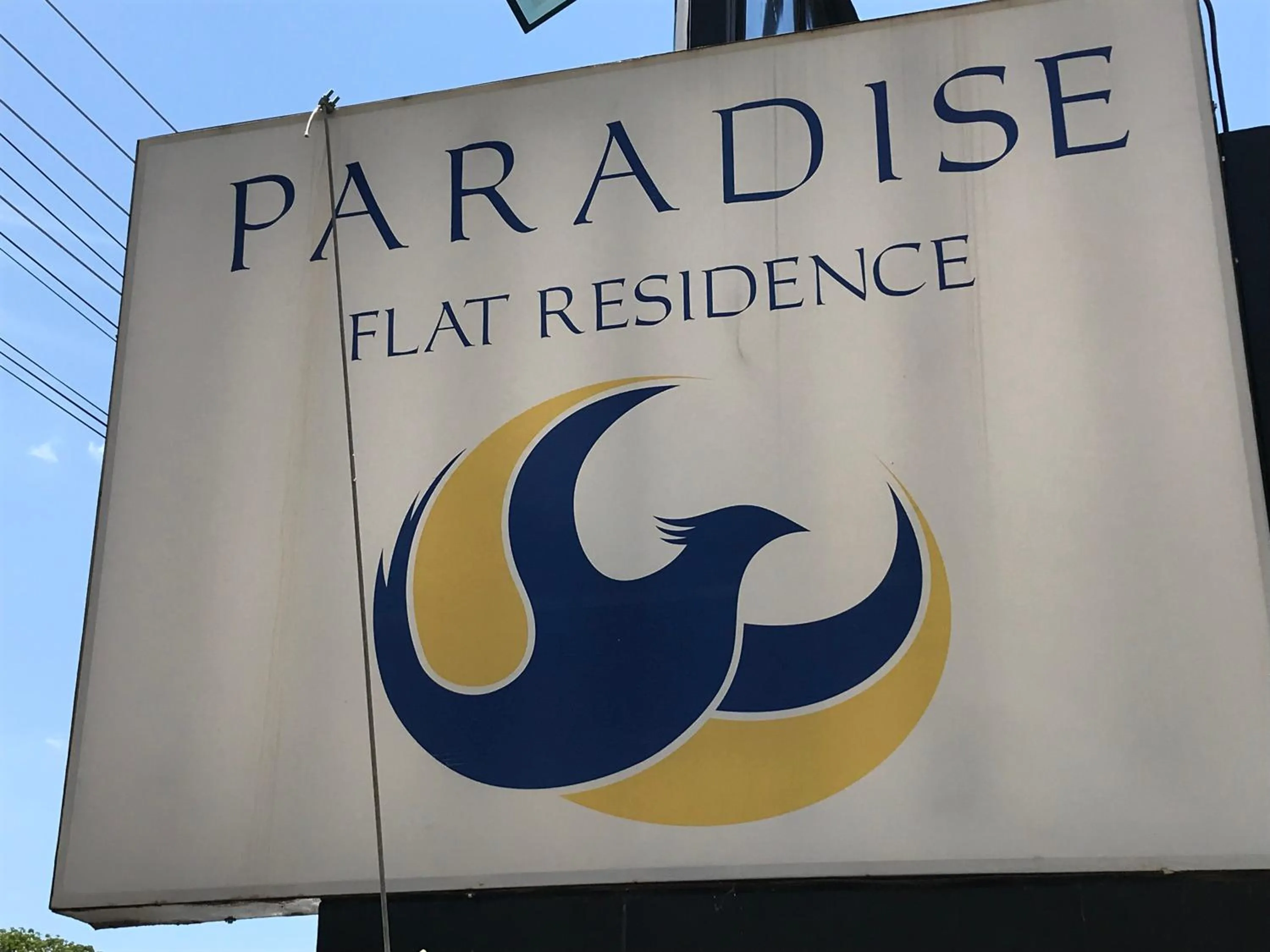 Property logo or sign in Paradise Flat Residence