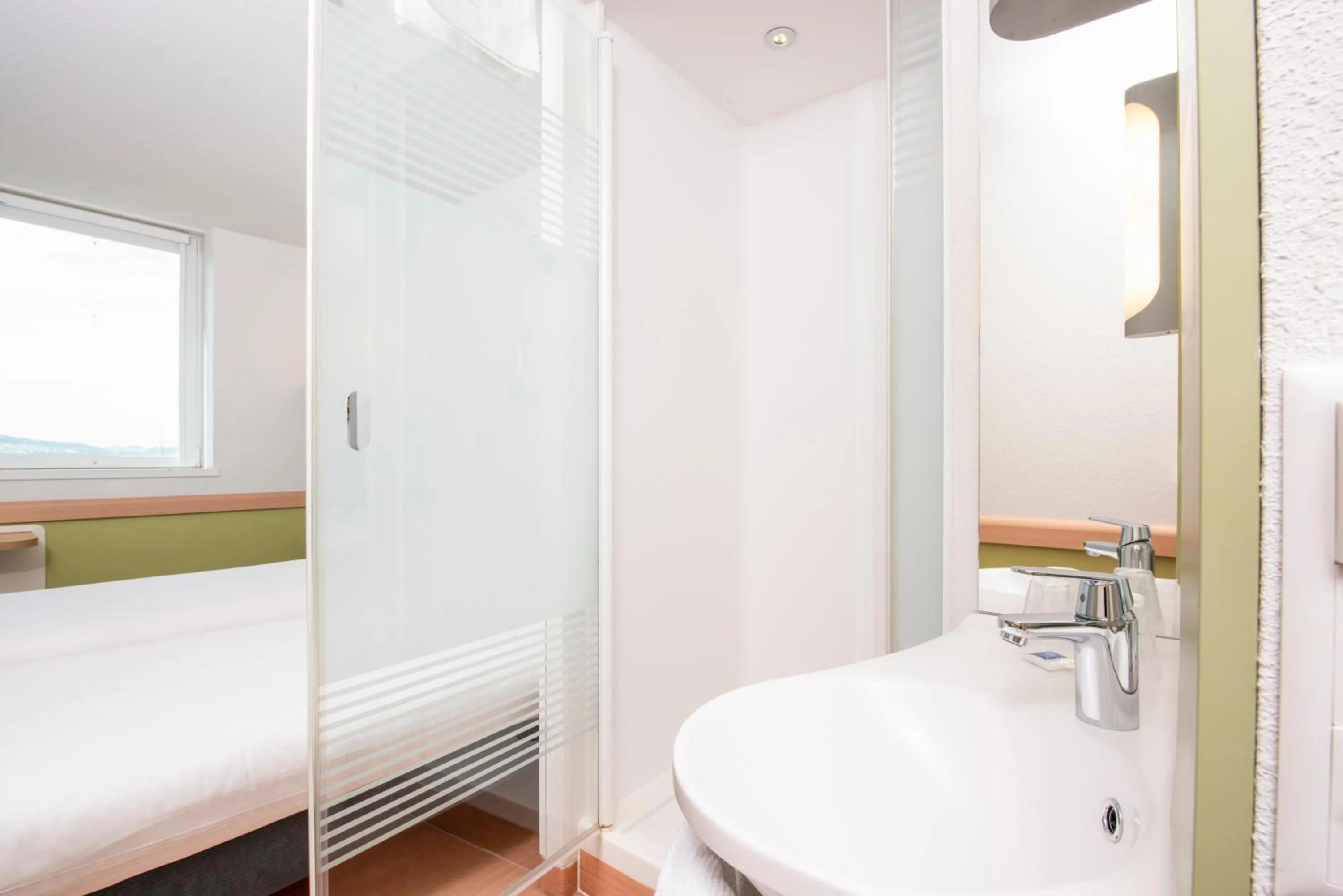 Bathroom, Bed in ibis budget Bern Expo