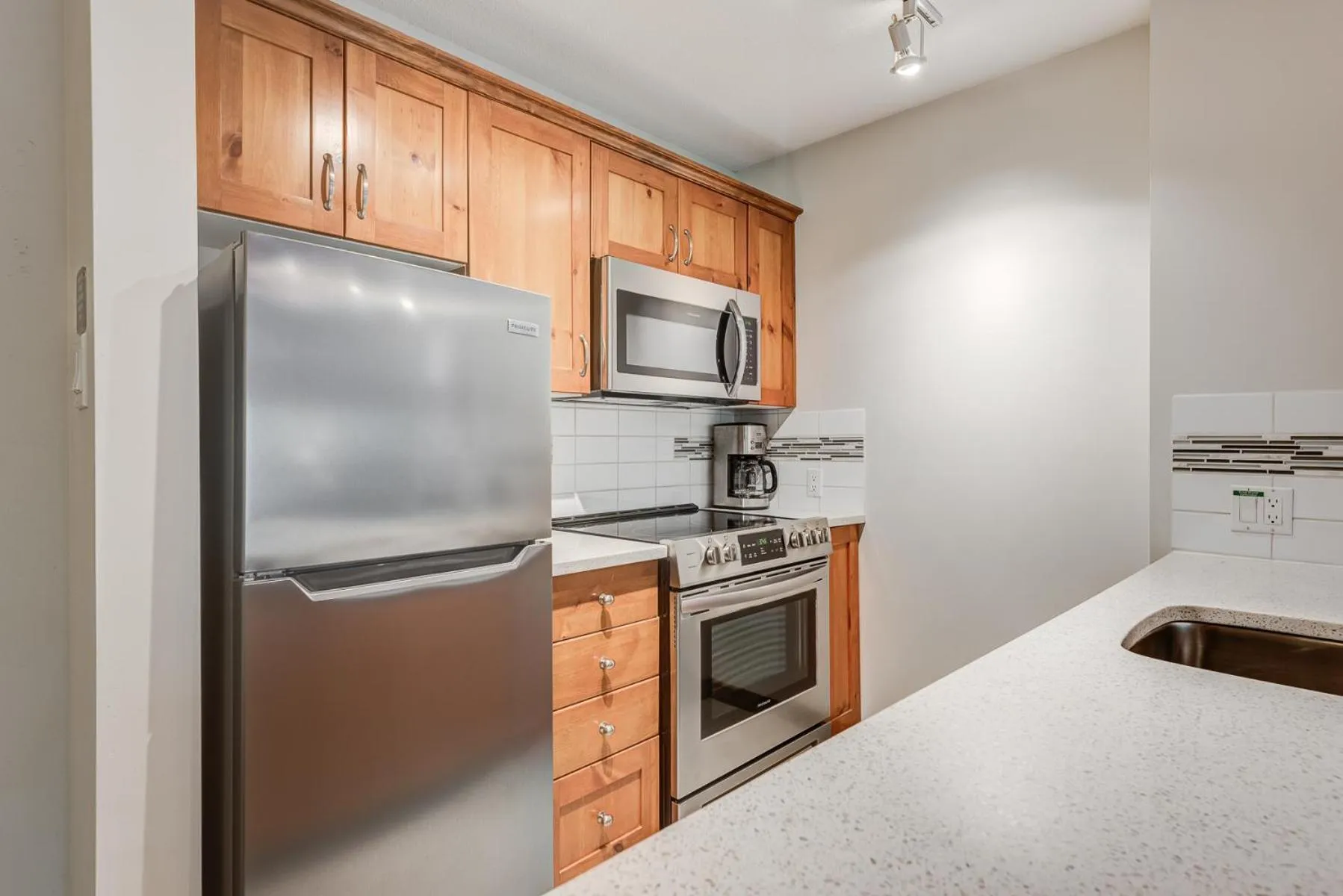 Kitchen or kitchenette in Blackcomb Springs Suites by CLIQUE