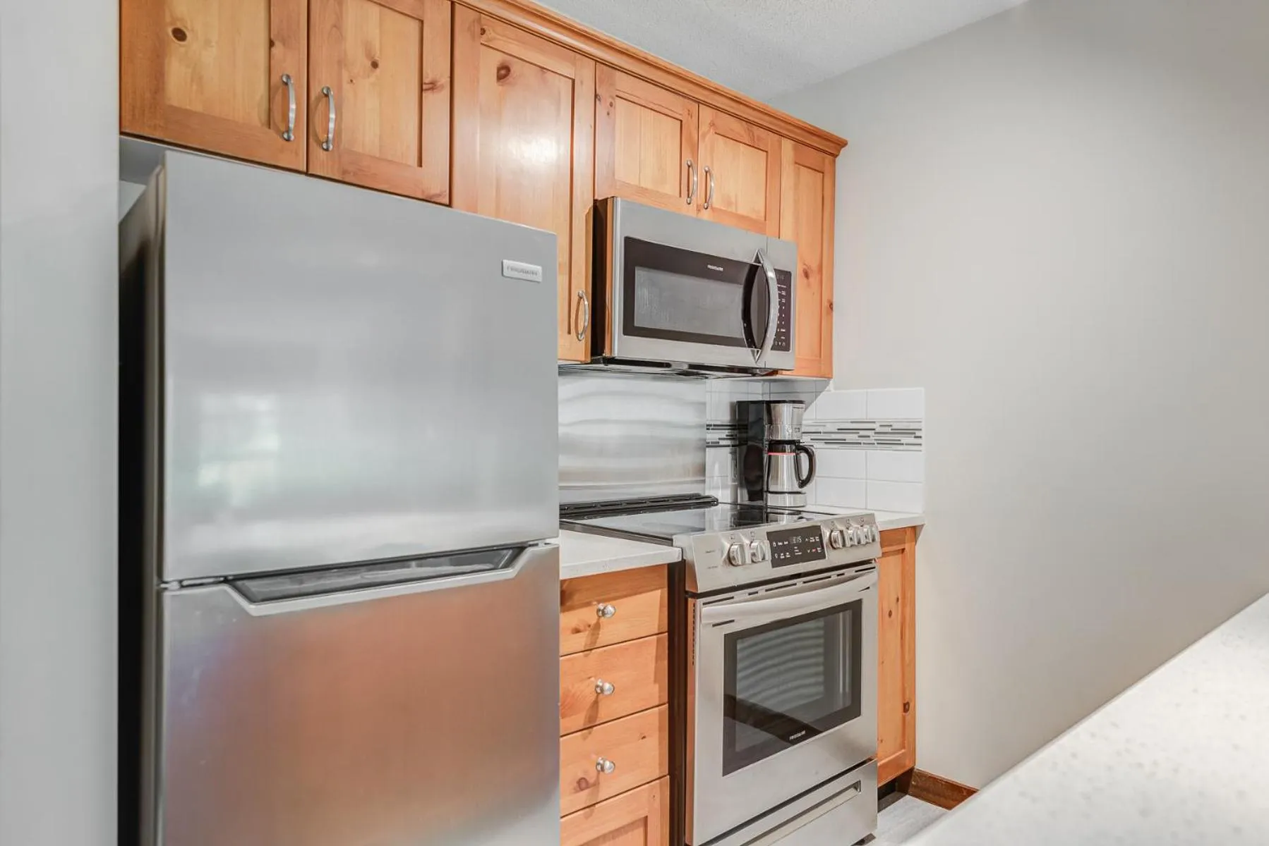 Kitchen or kitchenette in Blackcomb Springs Suites by CLIQUE
