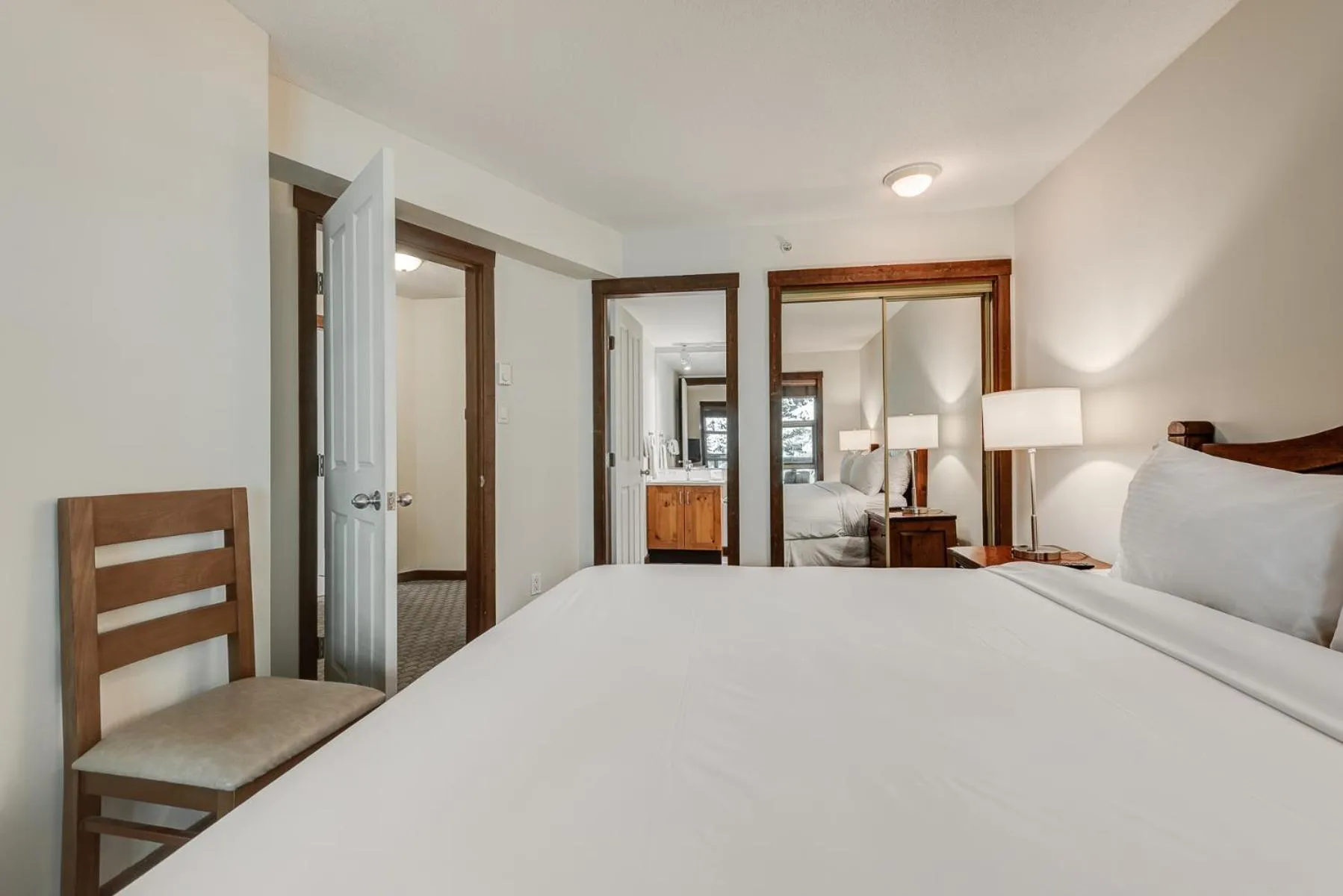 Bed in Blackcomb Springs Suites by CLIQUE
