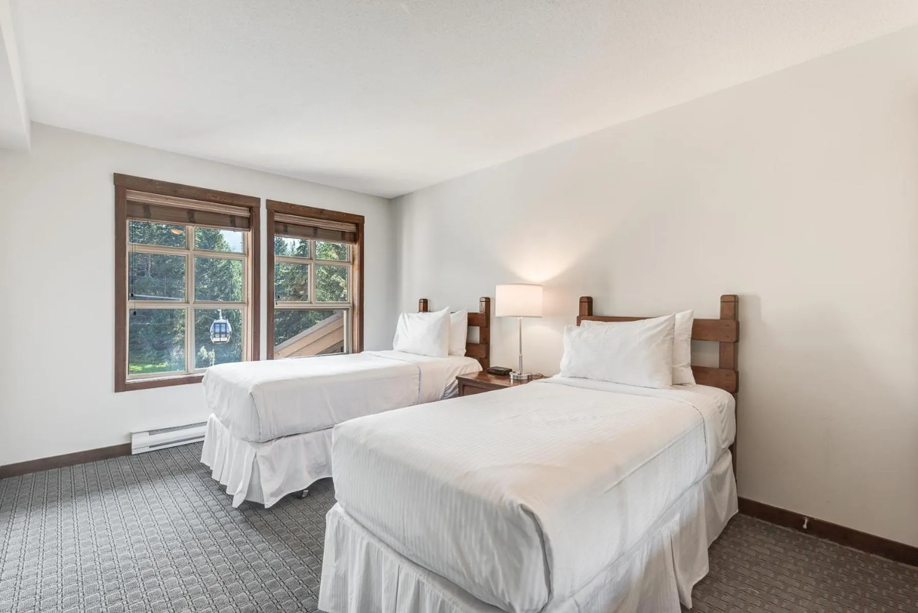 Bed in Blackcomb Springs Suites by CLIQUE