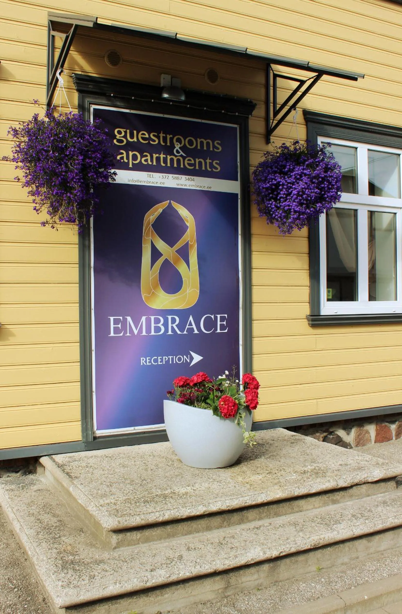 Property logo or sign in Embrace Hotel & Apartments