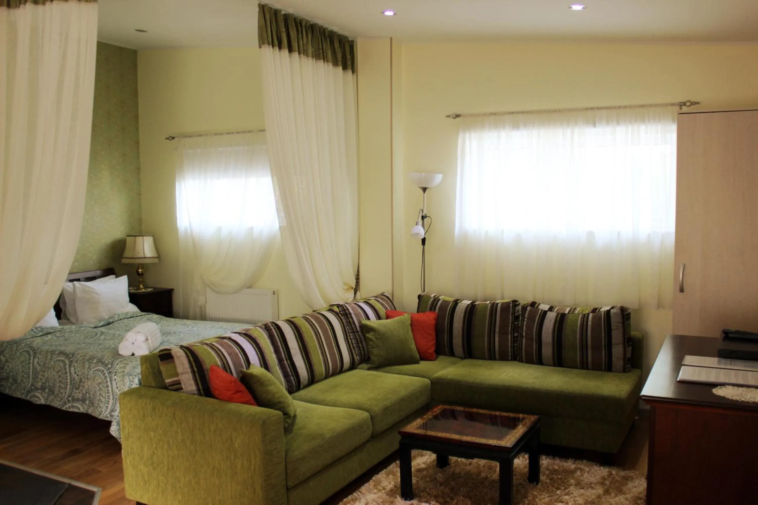 Living room, Bed in Embrace Hotel & Apartments