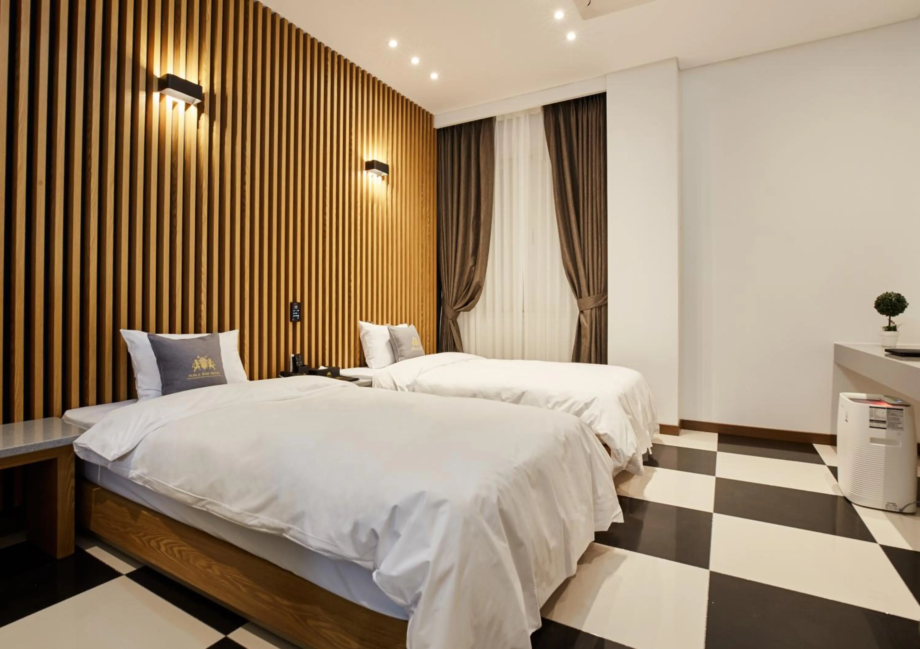 Bed in Noble Stay Hotel