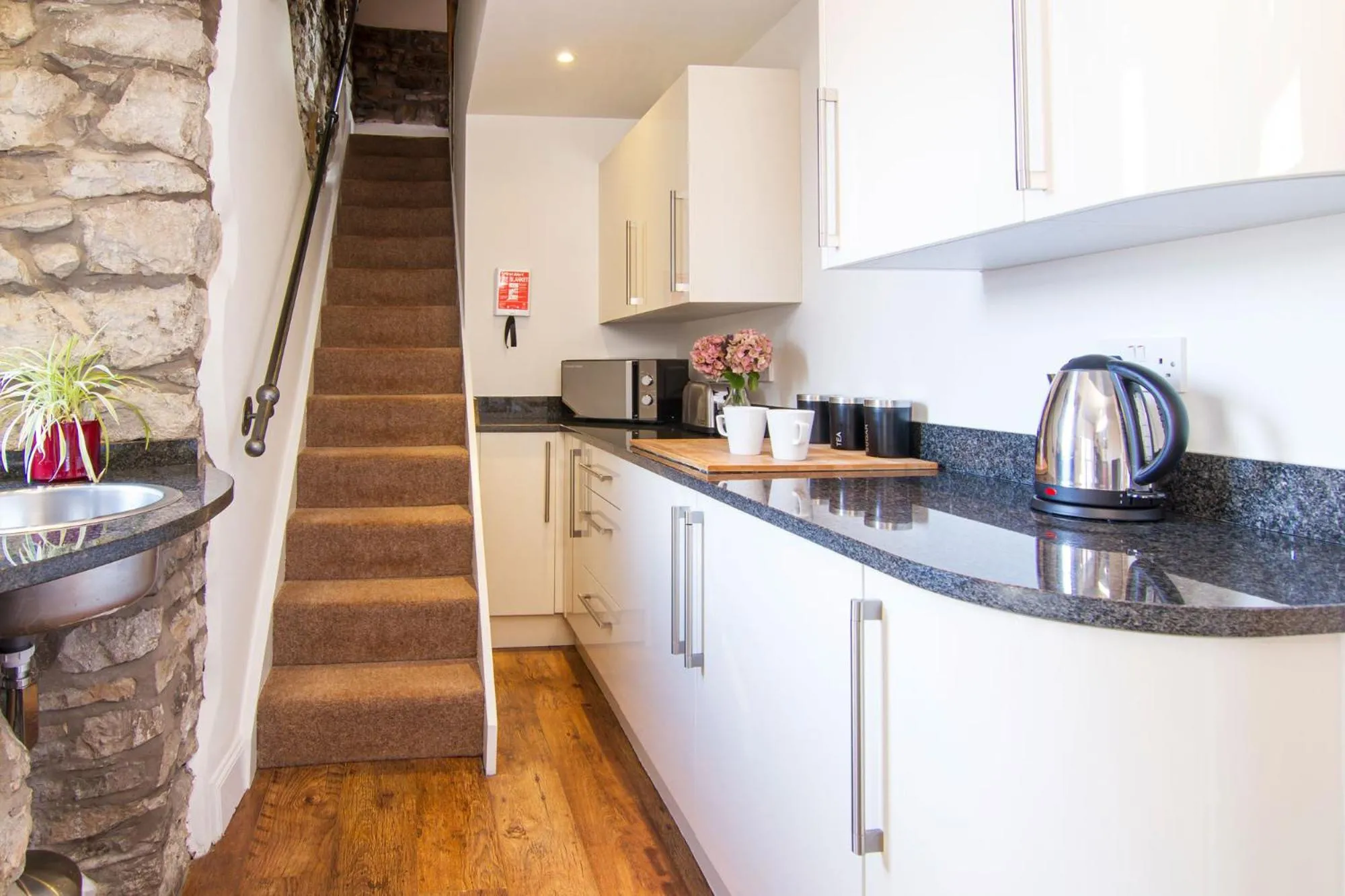 Kitchen or kitchenette in Romneys Apartments & Suites