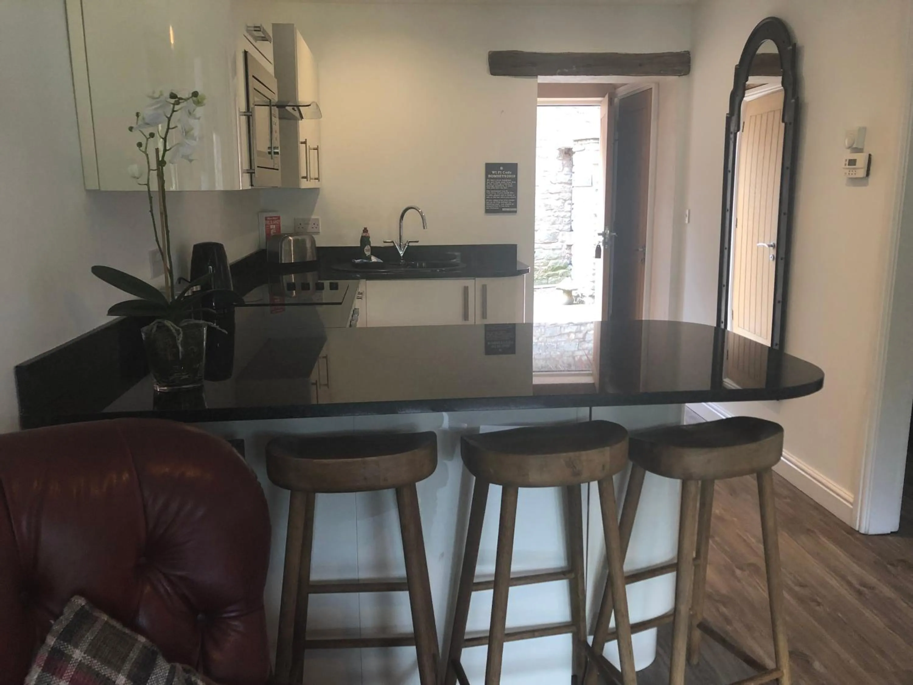 Kitchen or kitchenette in Romneys Apartments & Suites