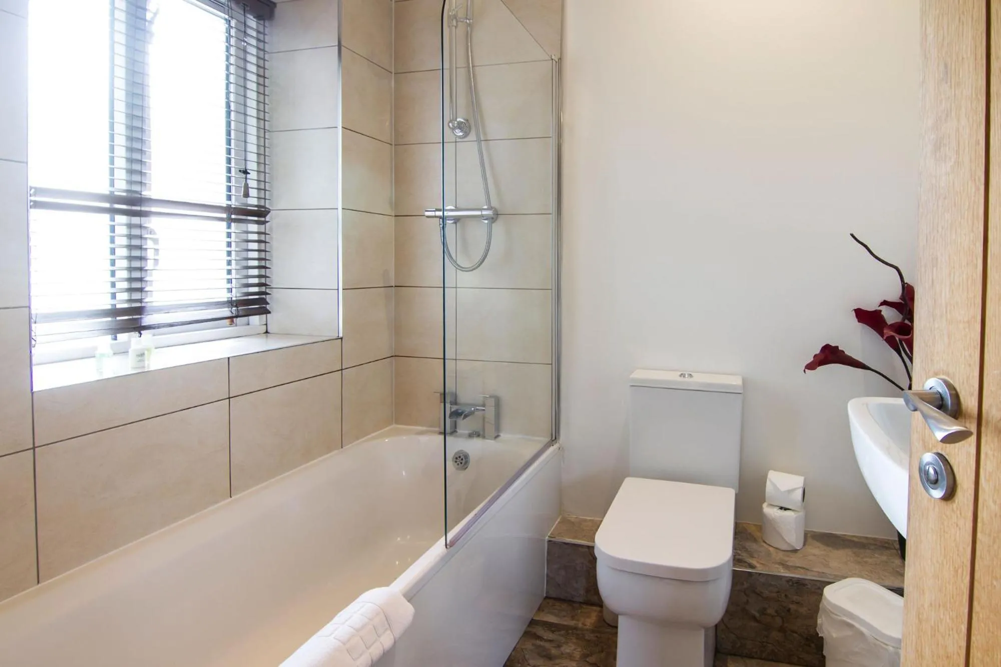 Bathroom in Romneys Apartments & Suites