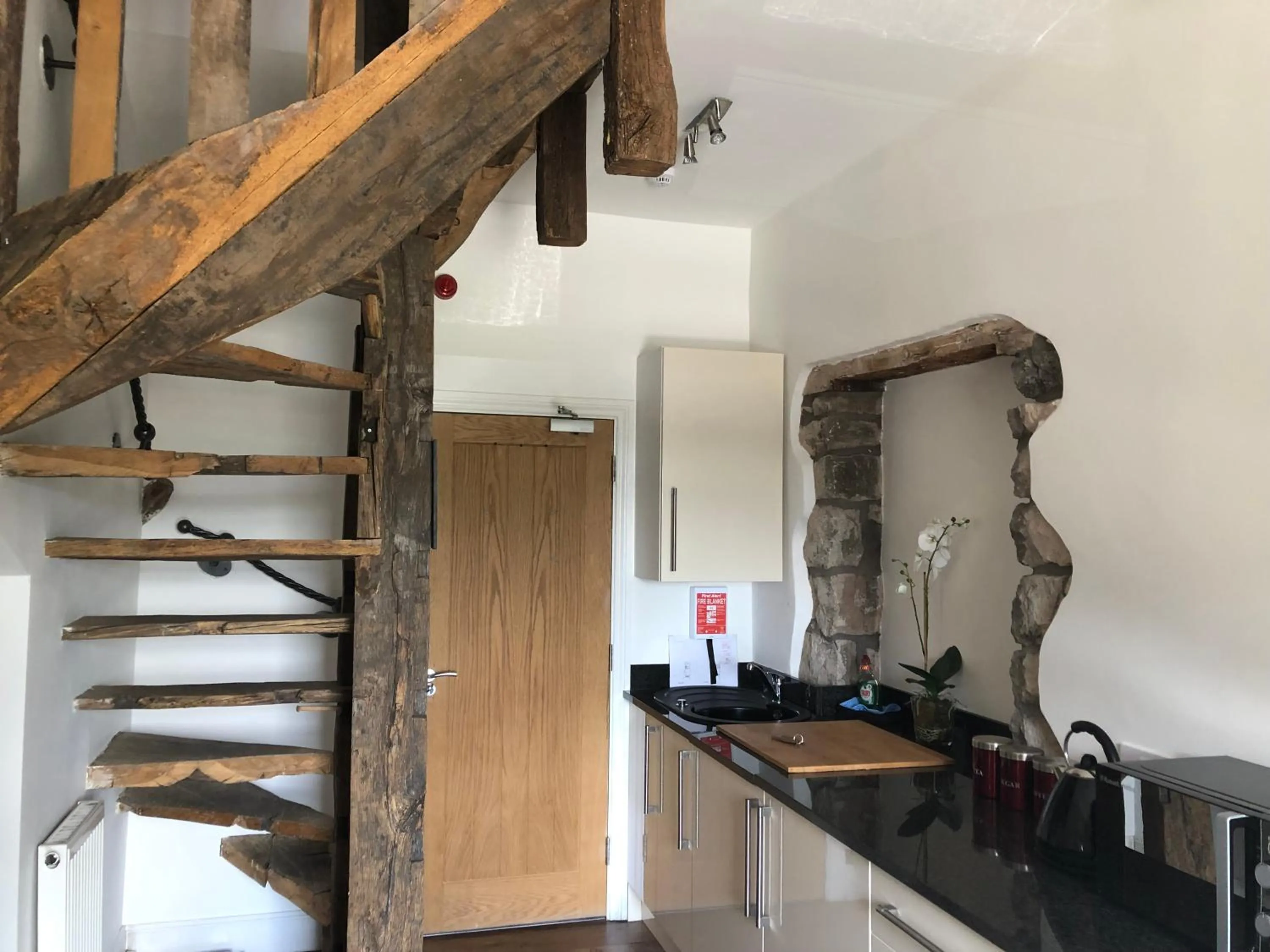 Kitchen or kitchenette in Romneys Apartments & Suites
