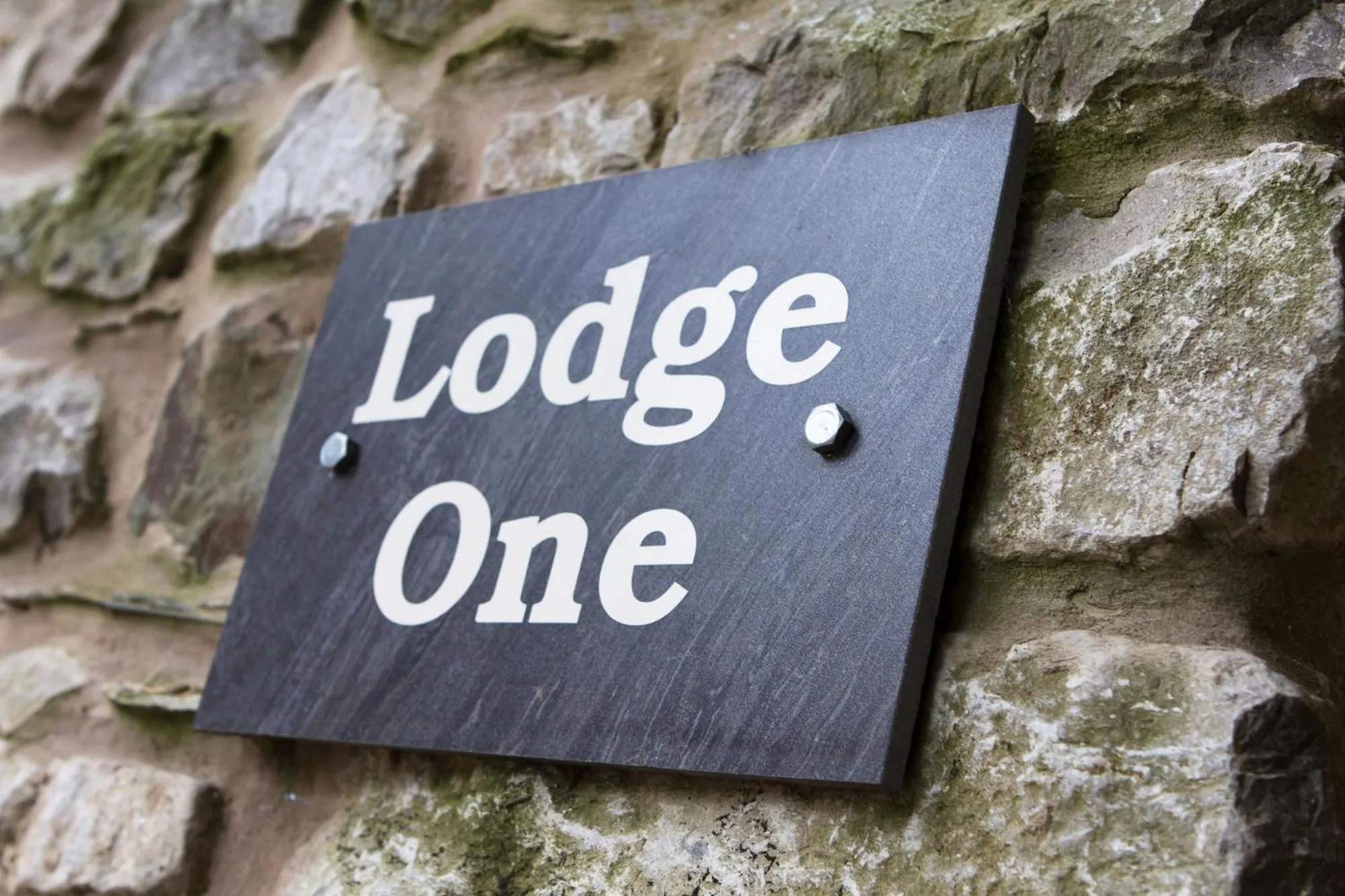 Property logo or sign in Romneys Apartments & Suites