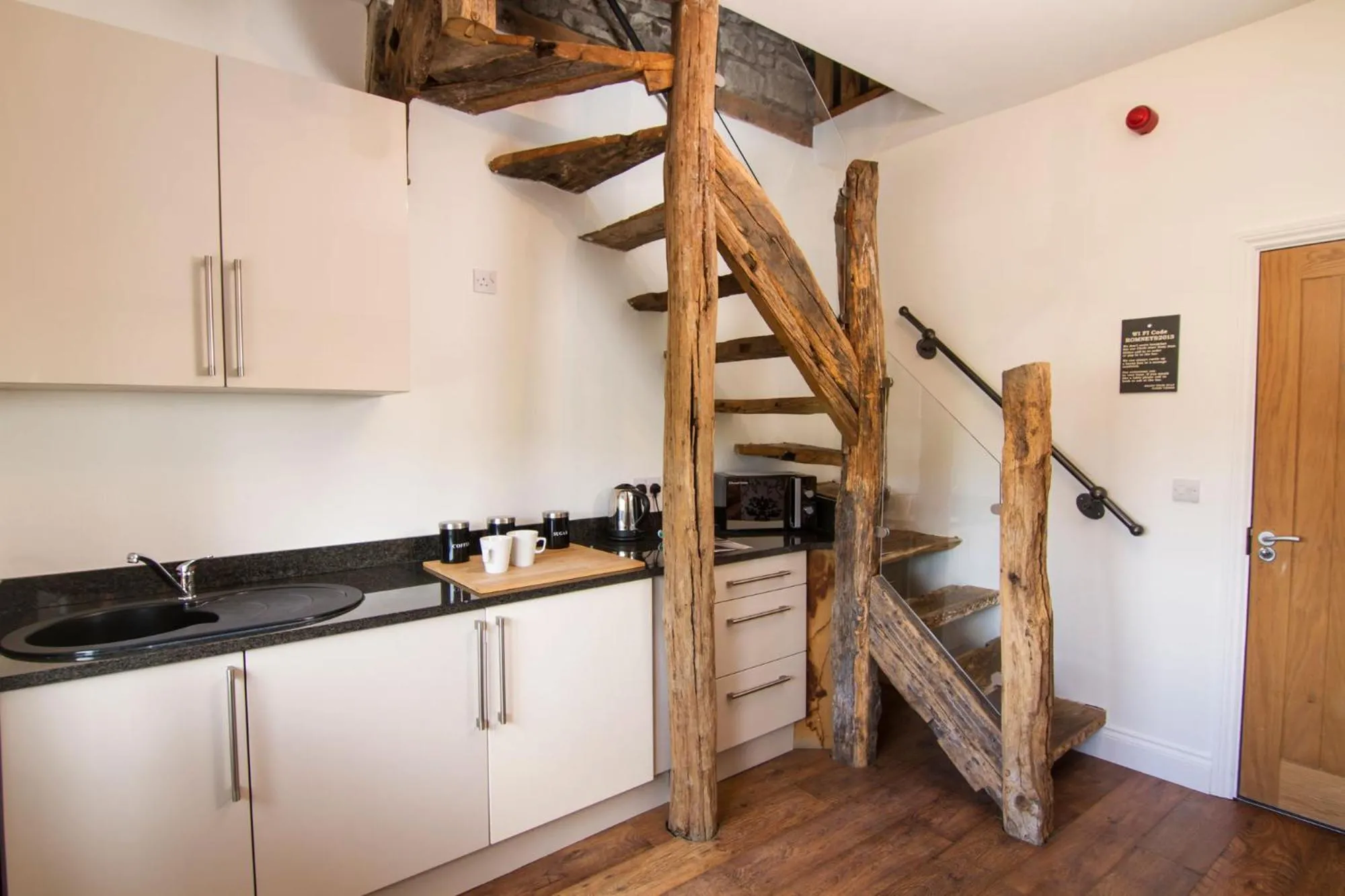 Kitchen or kitchenette in Romneys Apartments & Suites