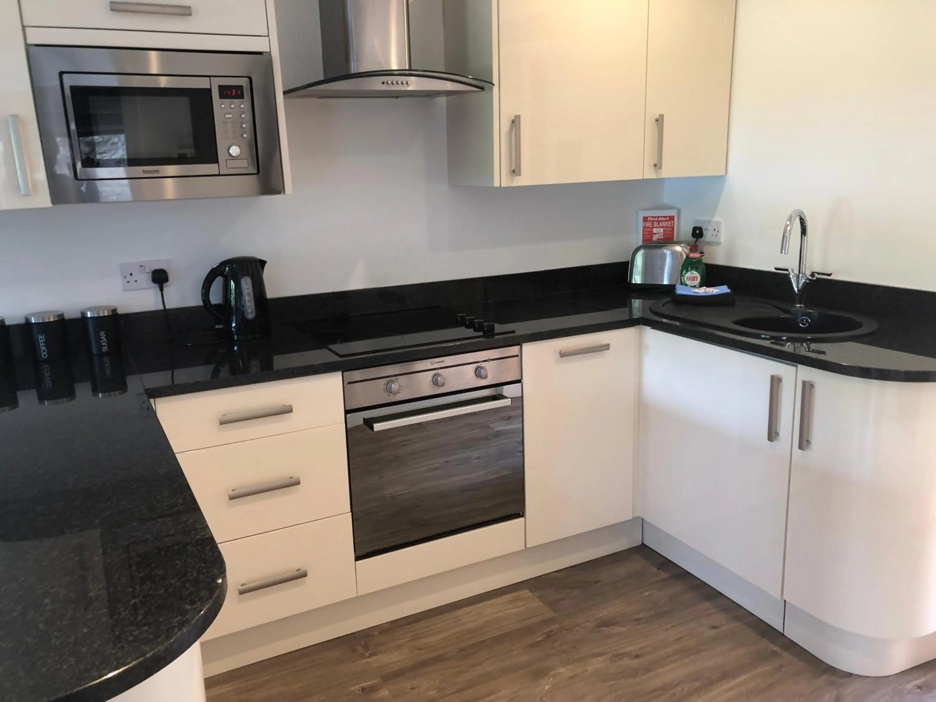 Kitchen or kitchenette in Romneys Apartments & Suites