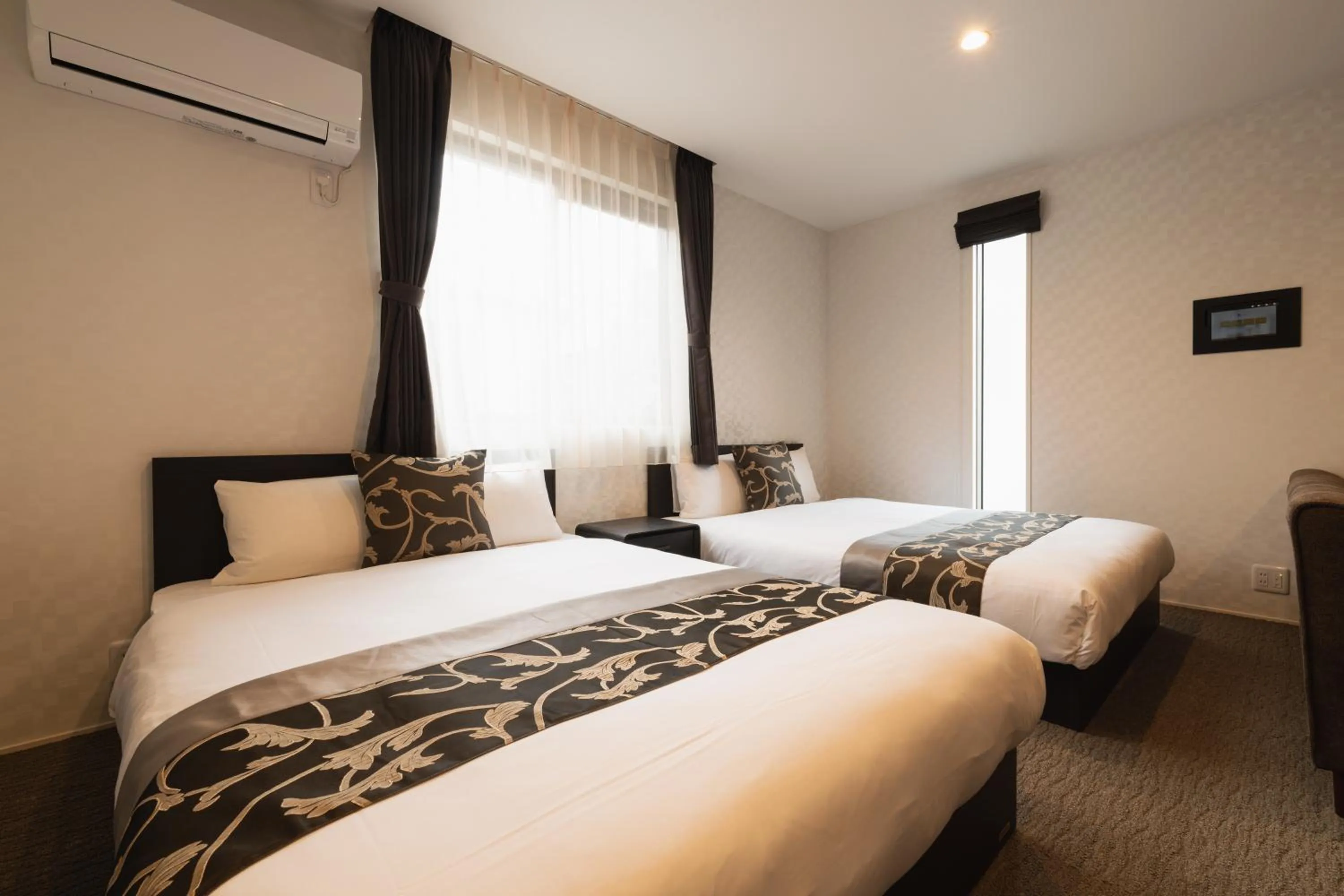 Bed in GRAND BASE Nagasaki Ekimae