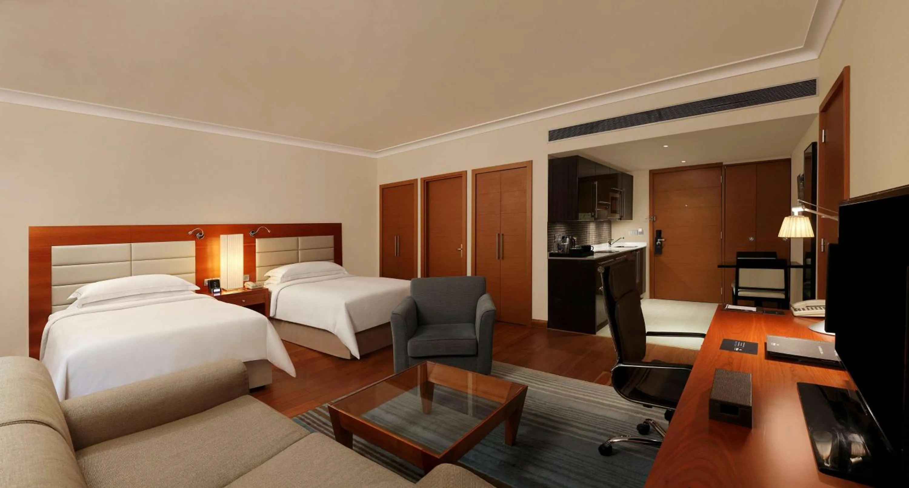Seating area, Bed in Hilton Bangalore Embassy GolfLinks