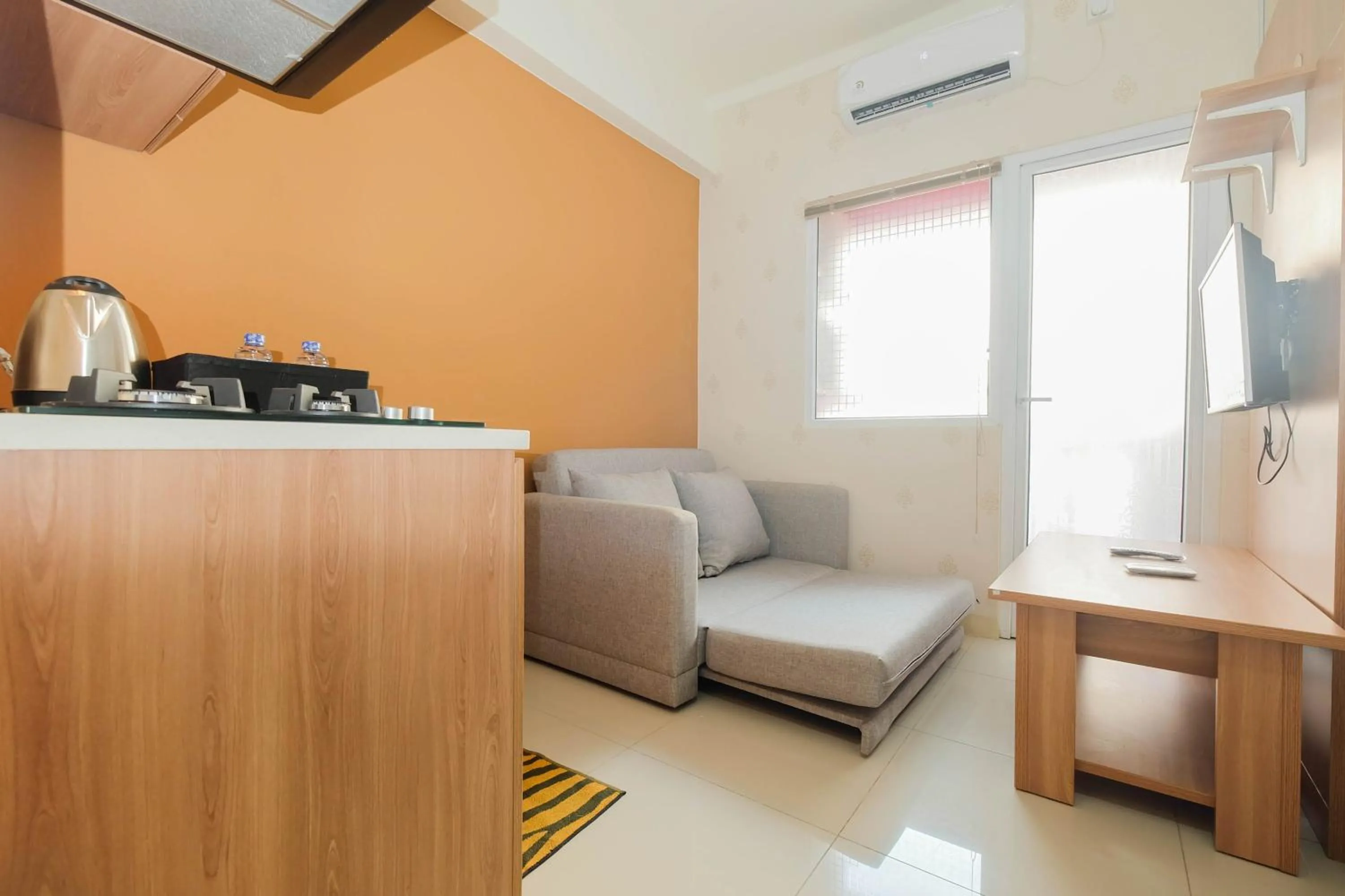 Living room in 2BR Apartment Green Pramuka City near Shopping Mall By Travelio