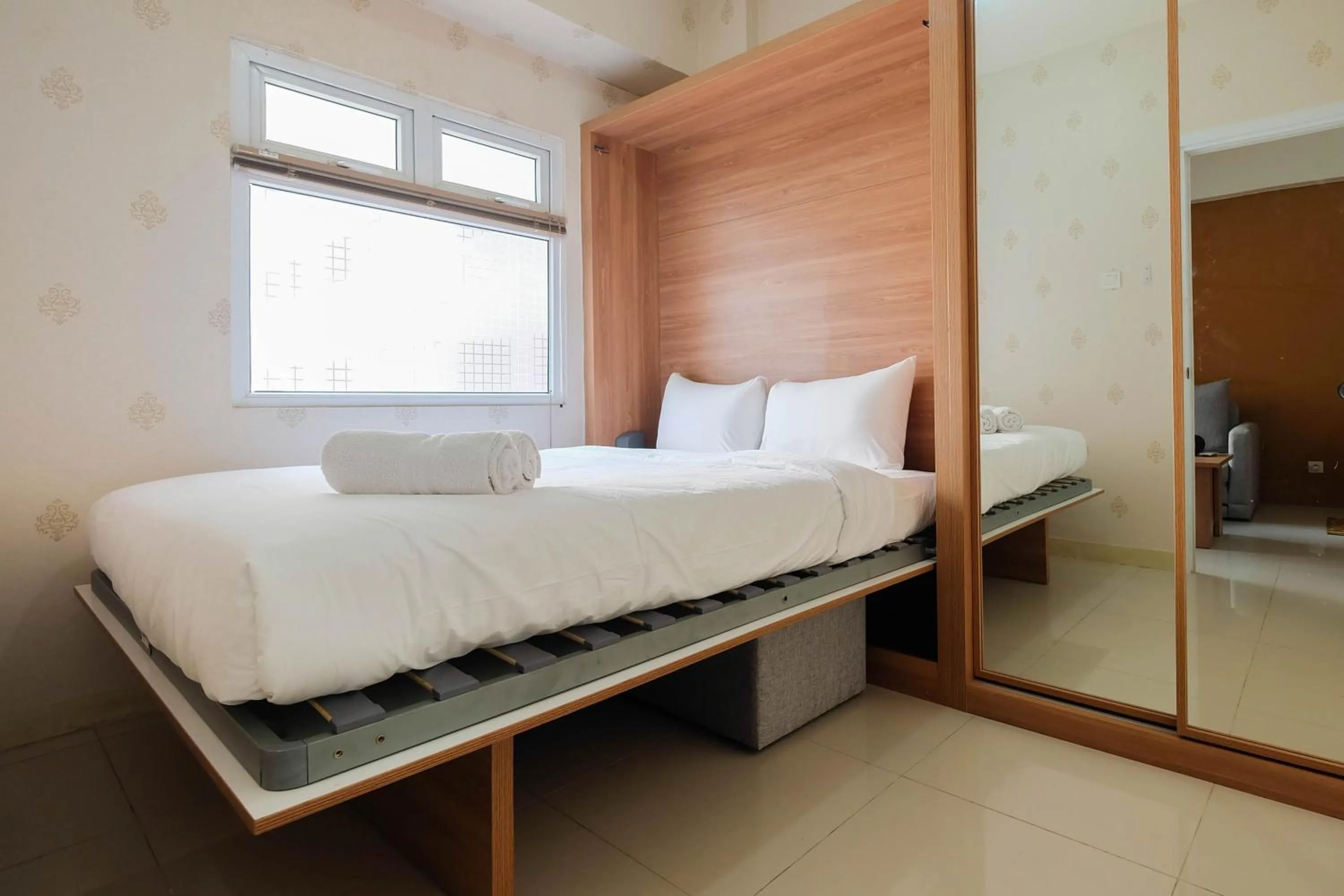 Bed in 2BR Apartment Green Pramuka City near Shopping Mall By Travelio