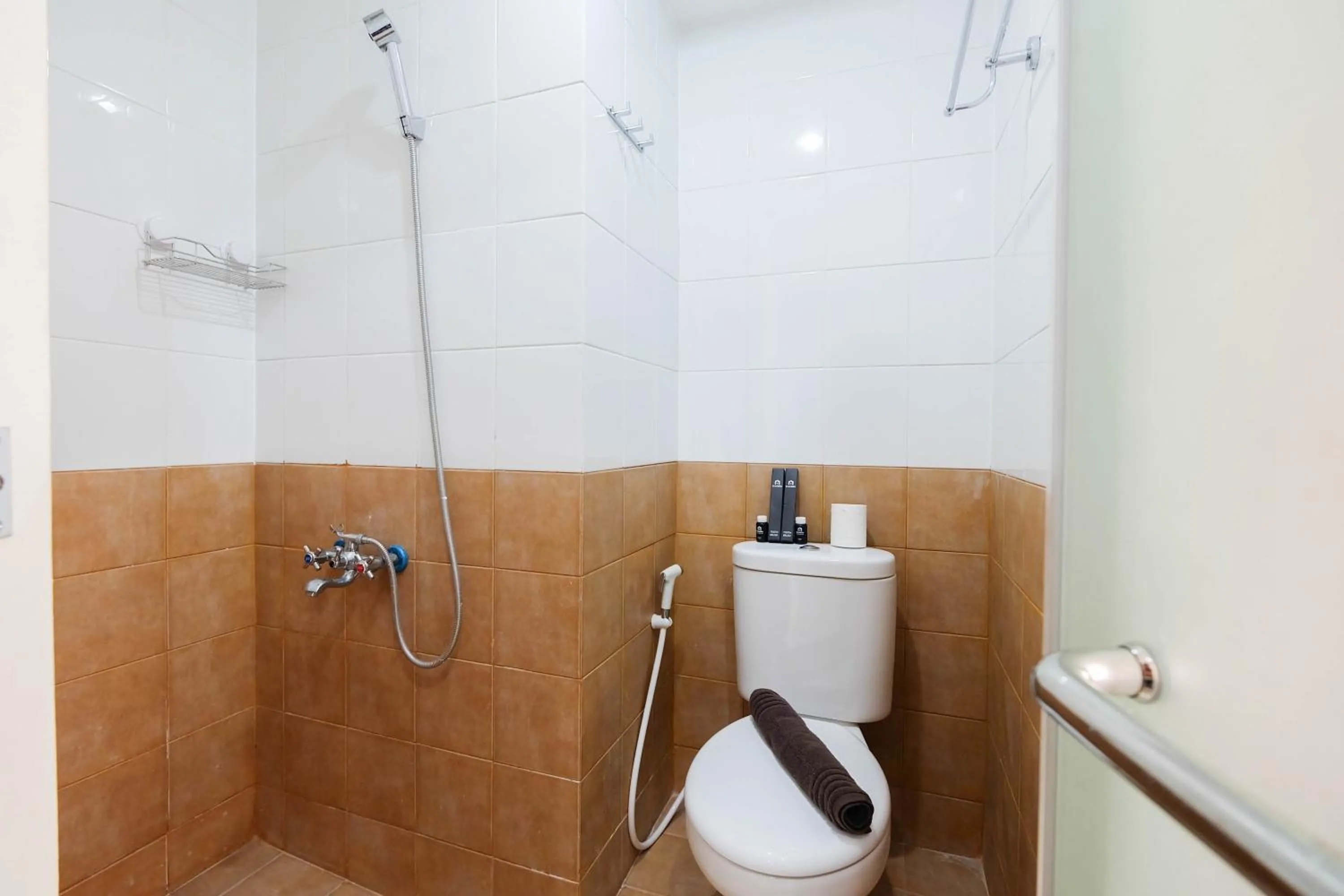 Bathroom in 2BR Apartment Green Pramuka City near Shopping Mall By Travelio