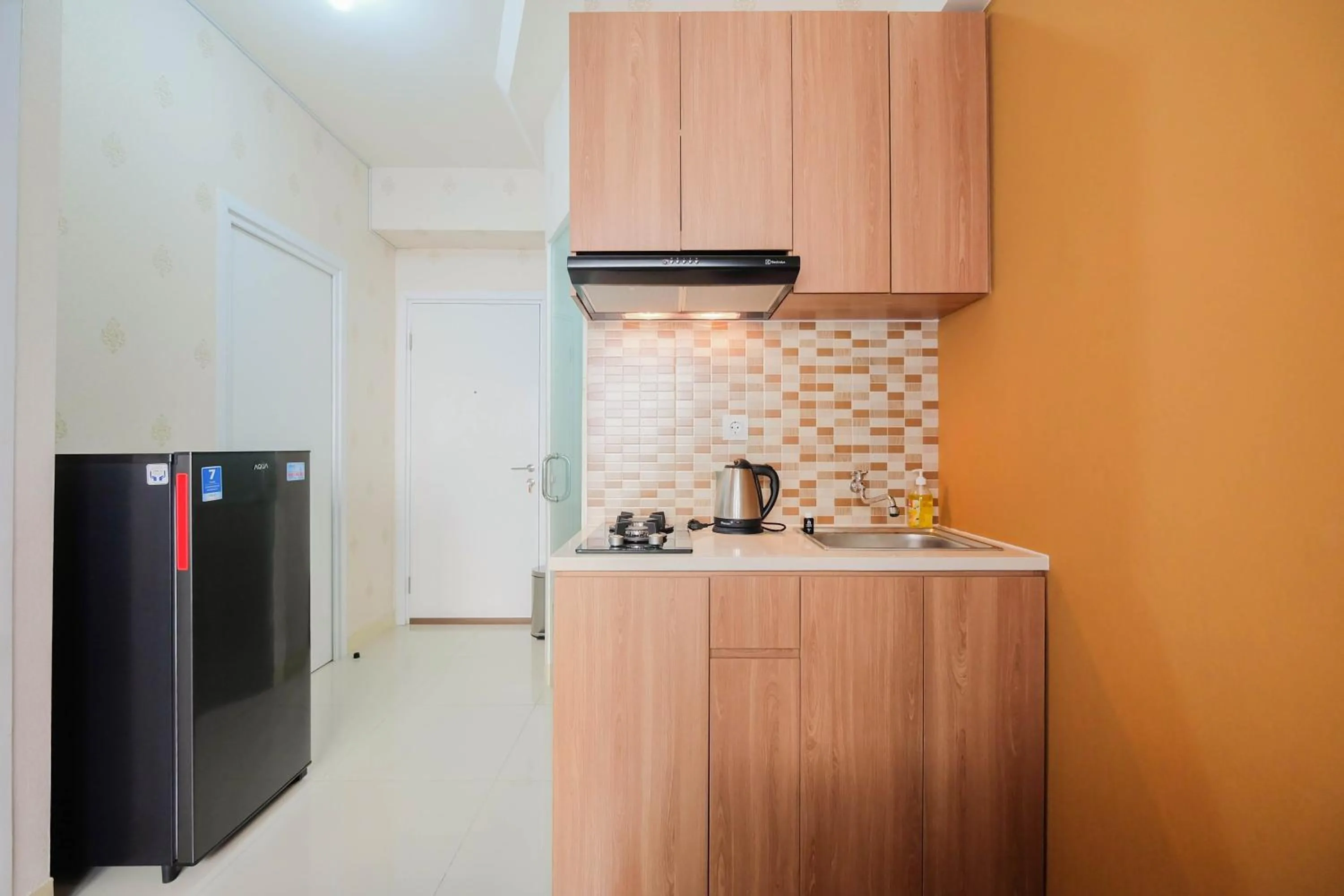 Kitchen or kitchenette in 2BR Apartment Green Pramuka City near Shopping Mall By Travelio