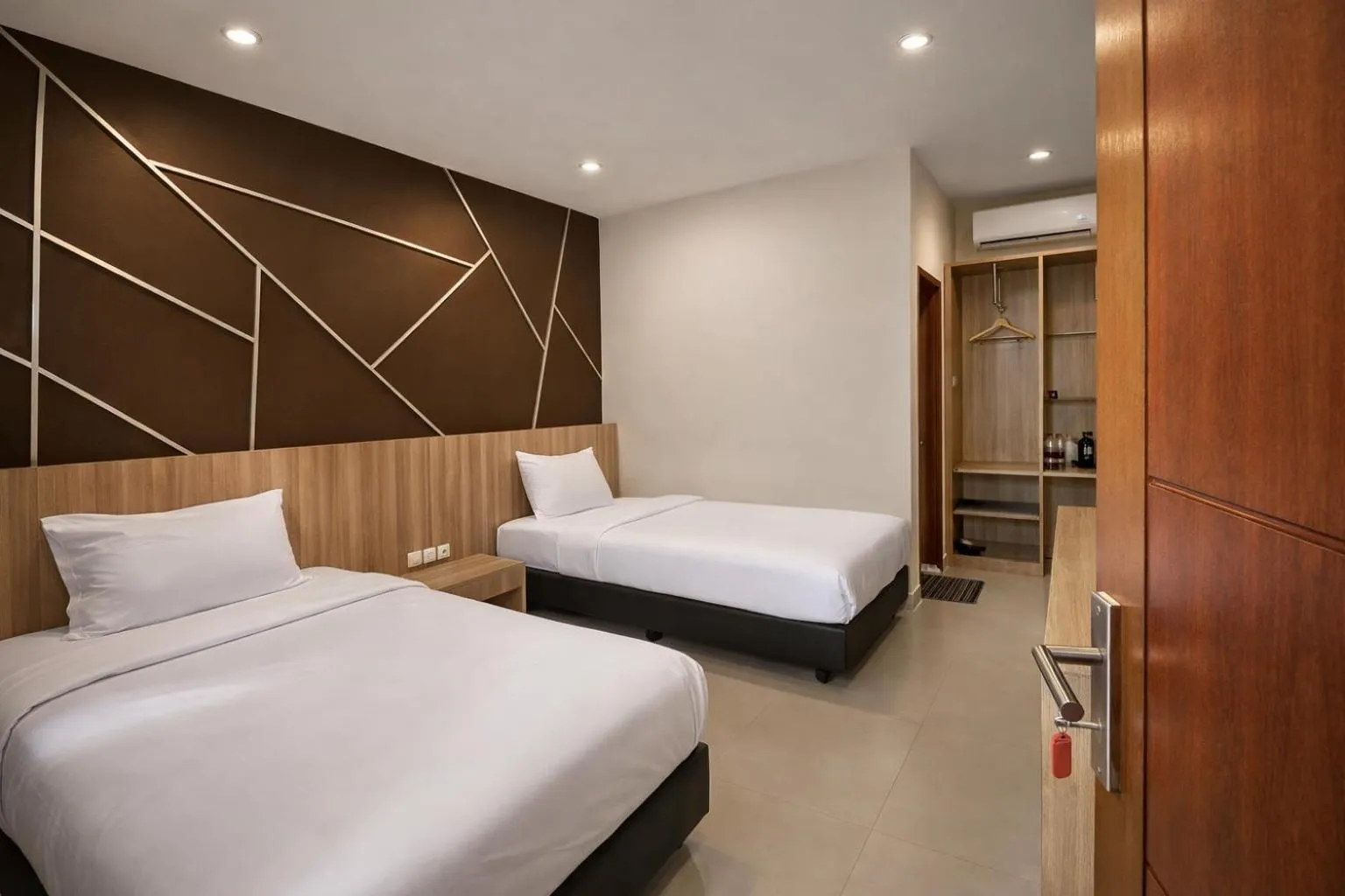 Bed in Grand Kuta Hotel Lombok - Pool - 43 inch Google TV - Strong 60Mbps WiFi - New Enhanced Management