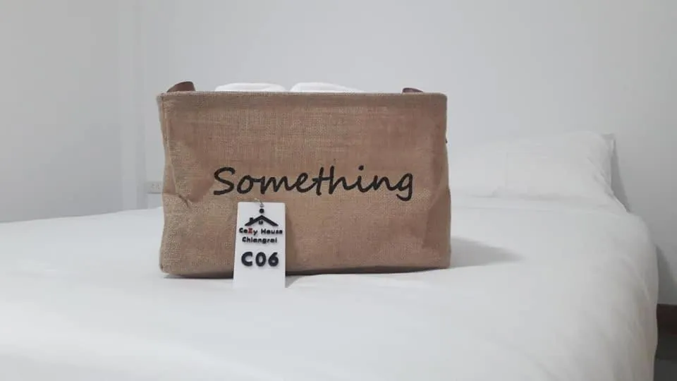 Bed in CoZyHouseChiangrai