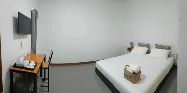 Bed in CoZyHouseChiangrai