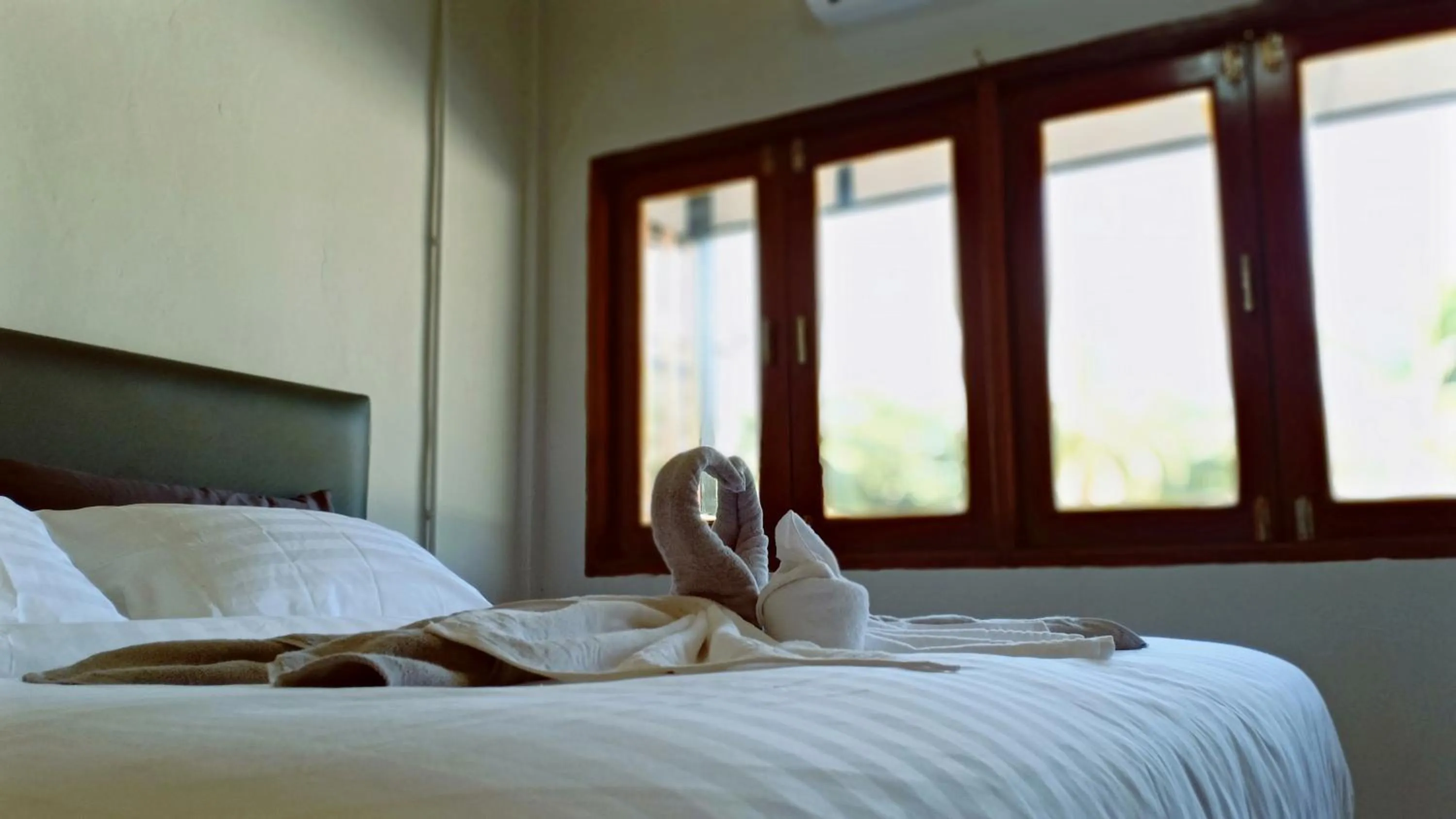 Bed in MOOK BOONCHU HOTEL