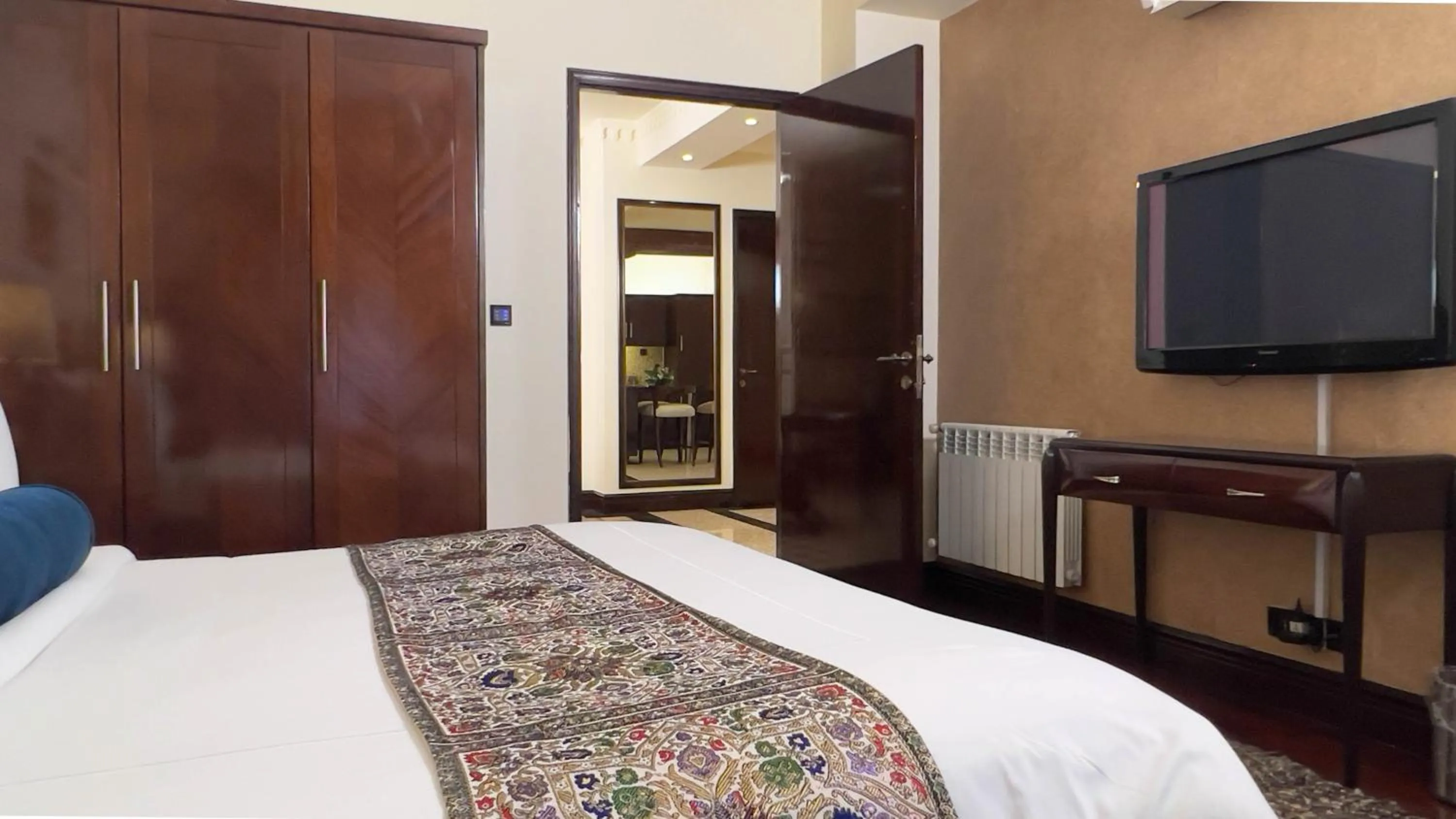 Bed in Heritage Luxury Suites All Suite Hotel