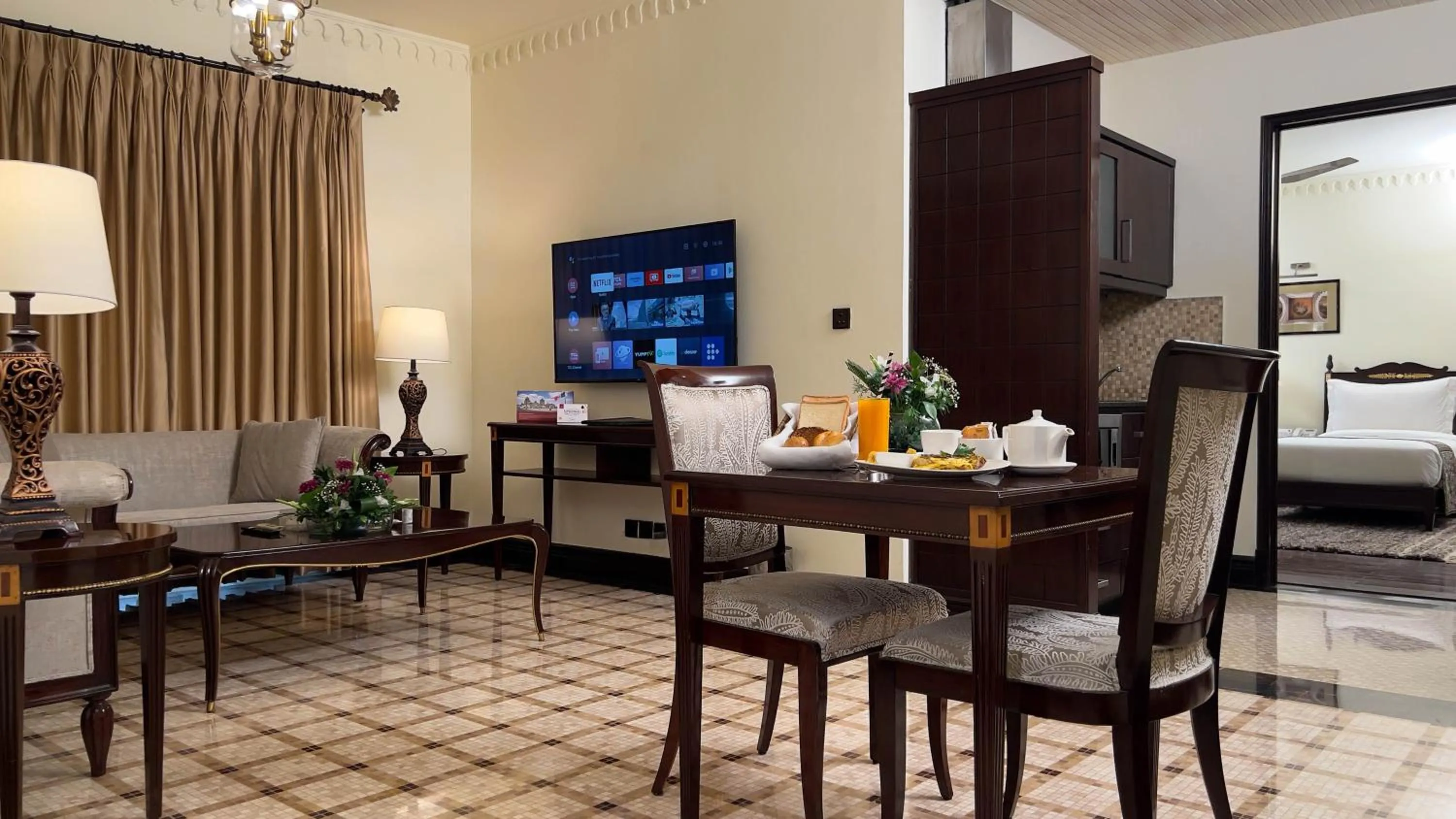 Communal lounge/ TV room in Heritage Luxury Suites All Suite Hotel