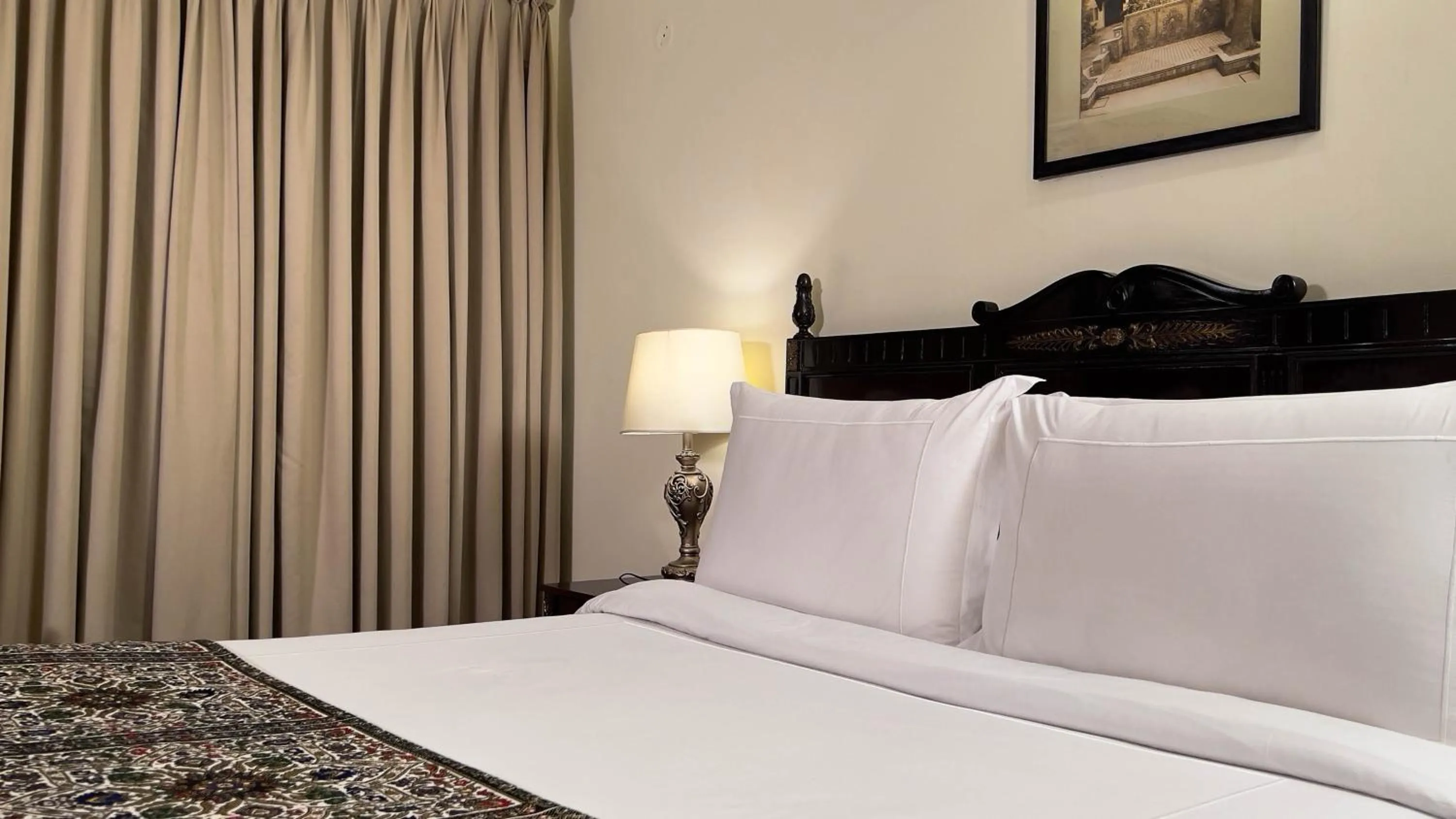 Bed in Heritage Luxury Suites All Suite Hotel